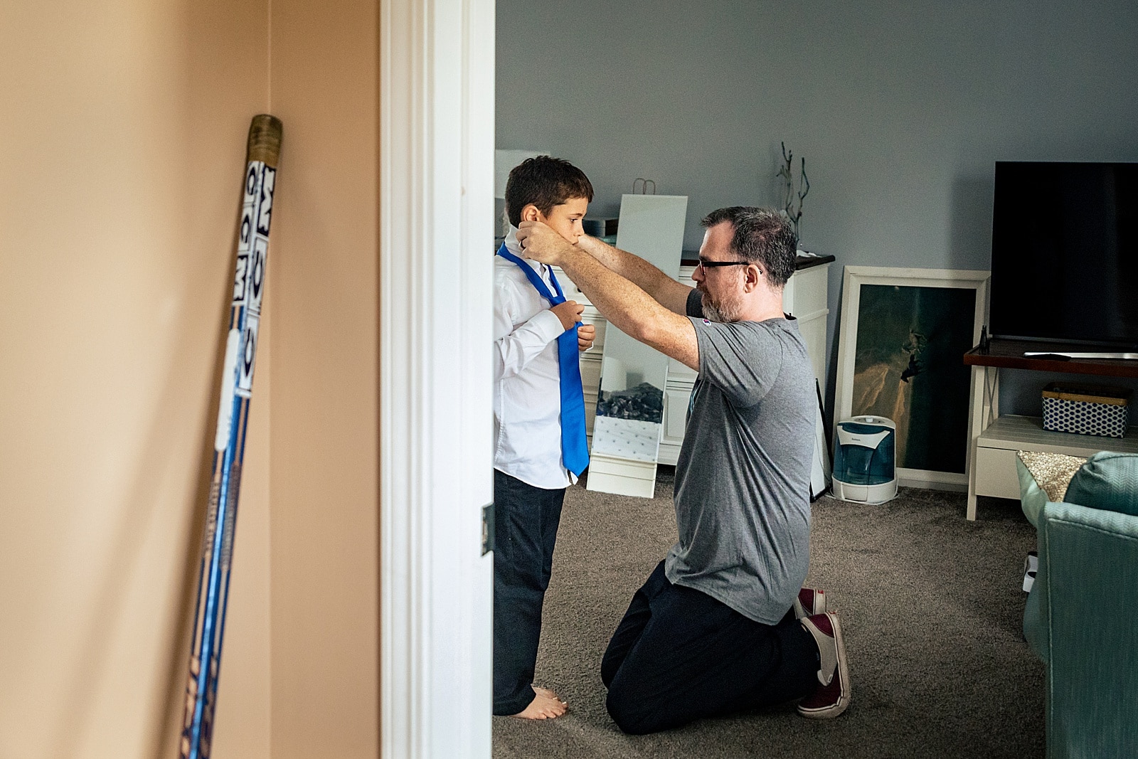 Groom helps his son get ready on the wedding day