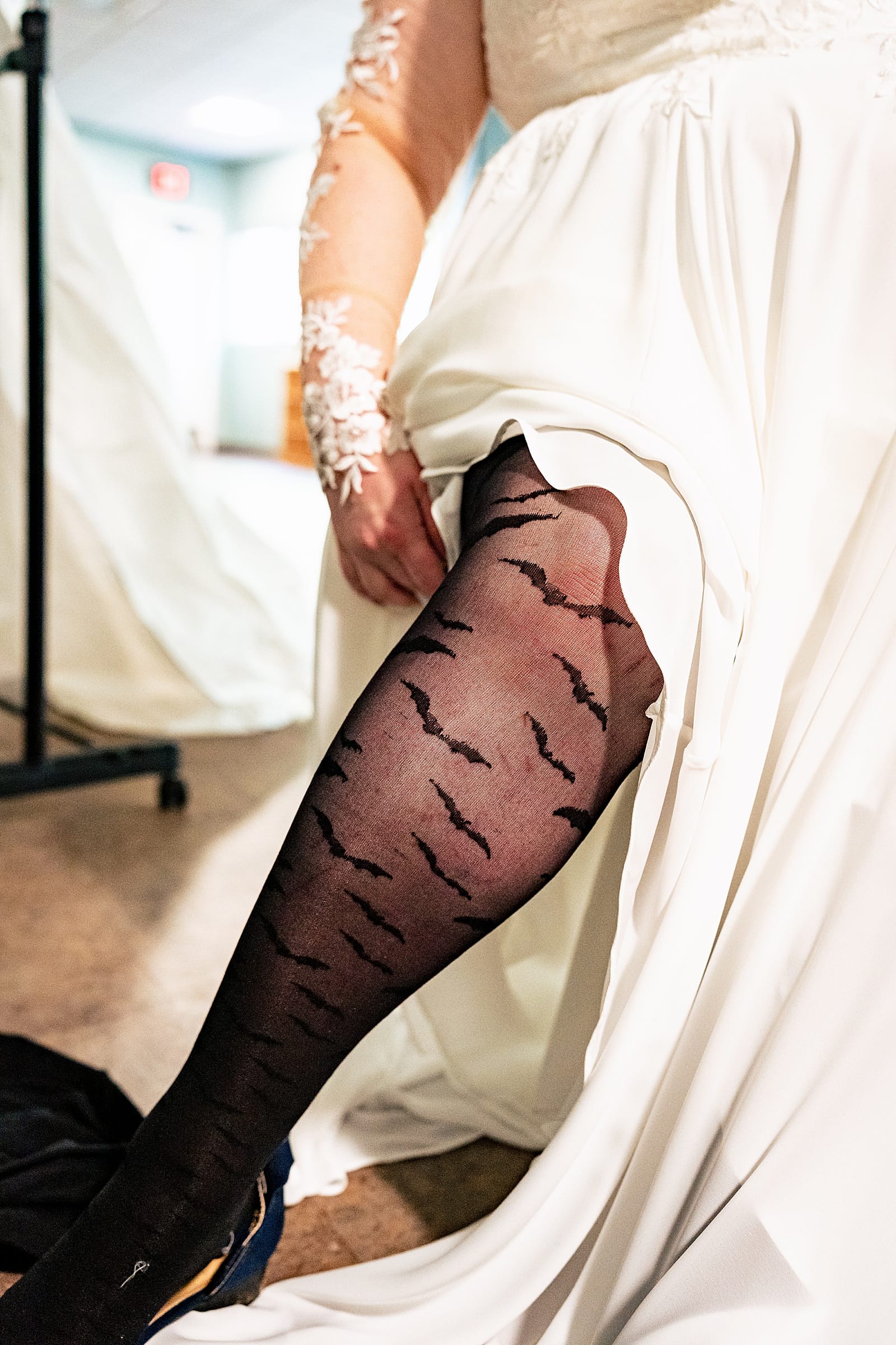 this bride wore bat tights under her wedding dress for her Edgar Allan Poe themed Halloween wedding