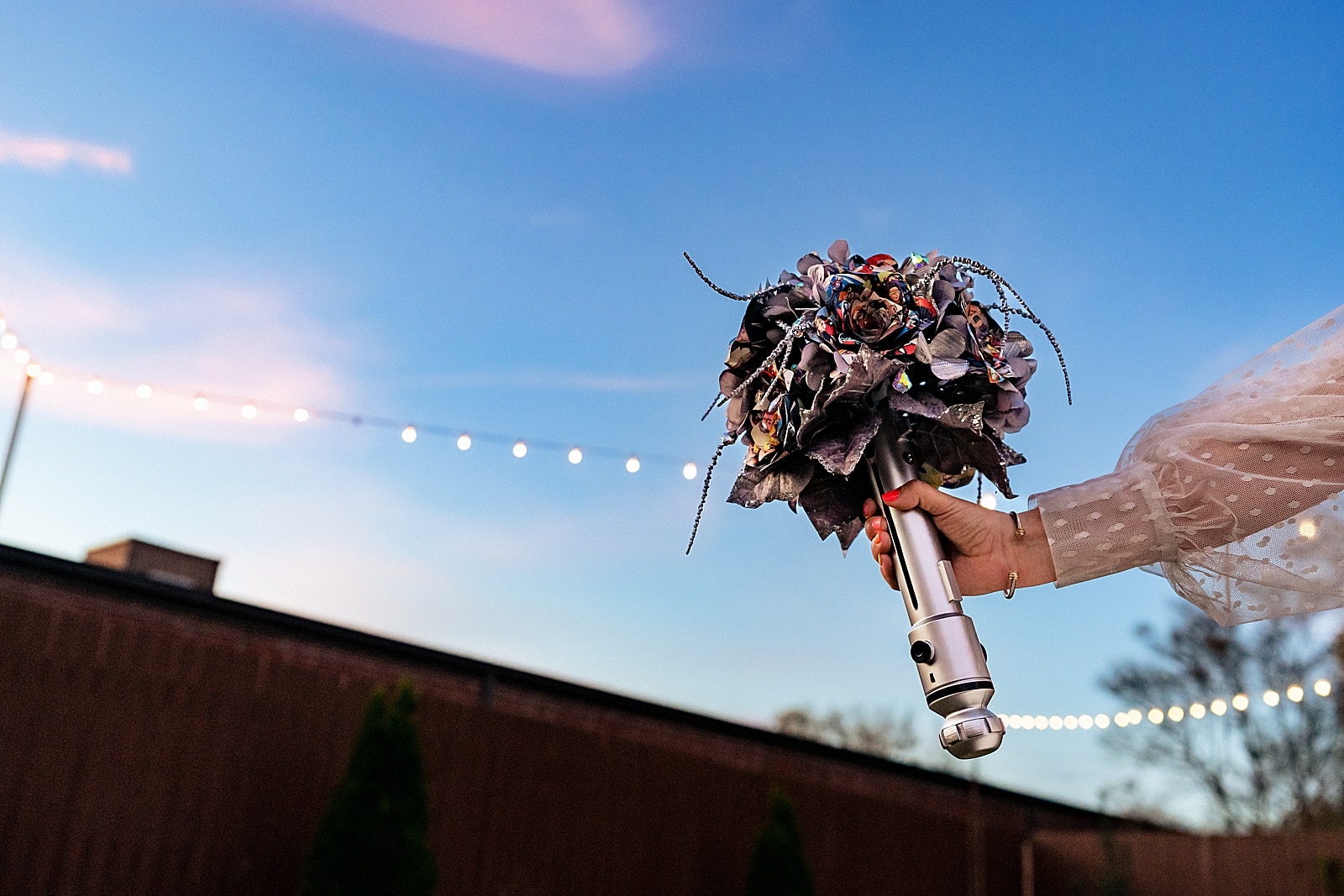 This bride's bouquet had a lightsaber hilt and origami flowers made of comic book pages