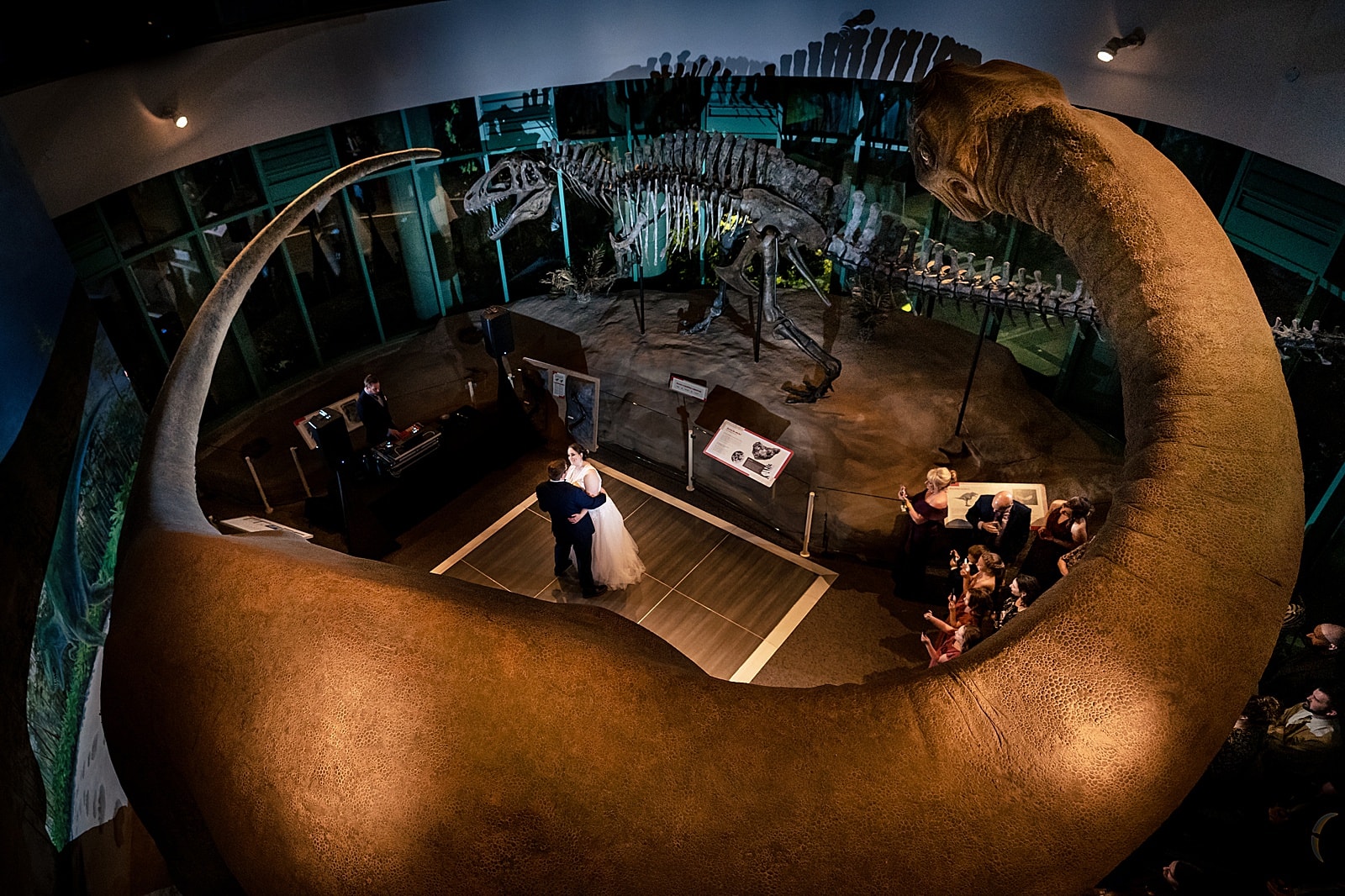 this first dance at a Science museum wedding had the couple dancing surrounded by dinosaurs