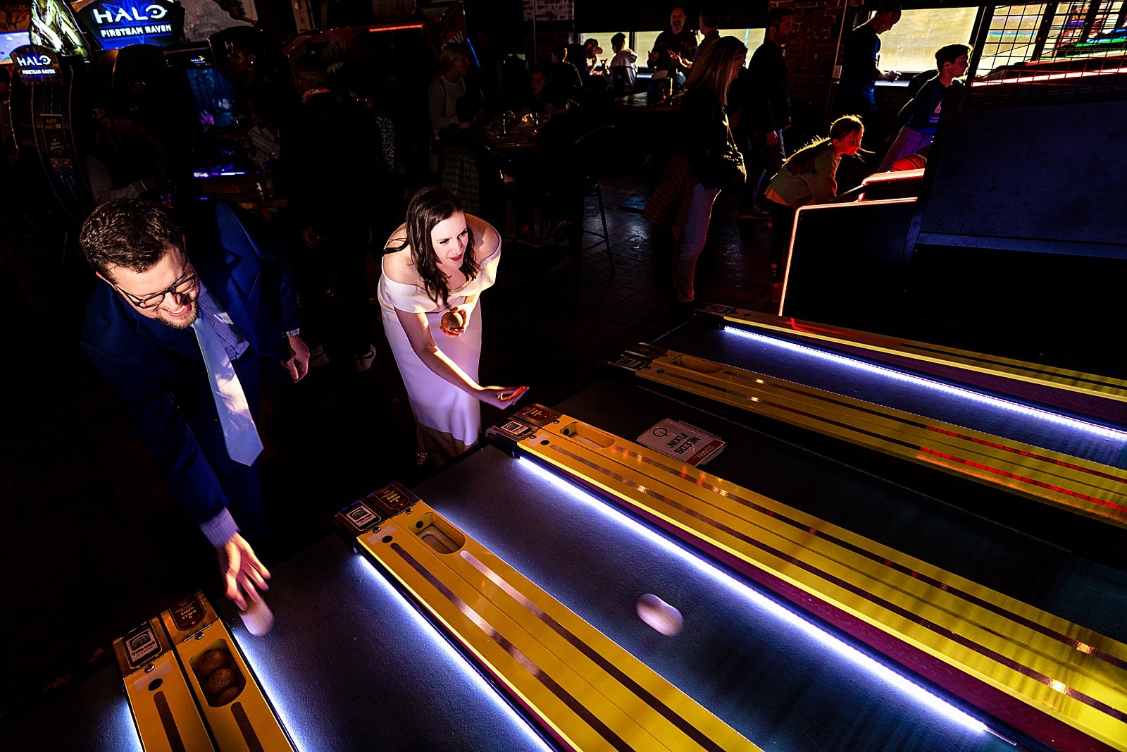 Bride and groom playing arcade games at a Boxcar Bar + Arcade wedding by Durham wedding photographers Kivus & Camera