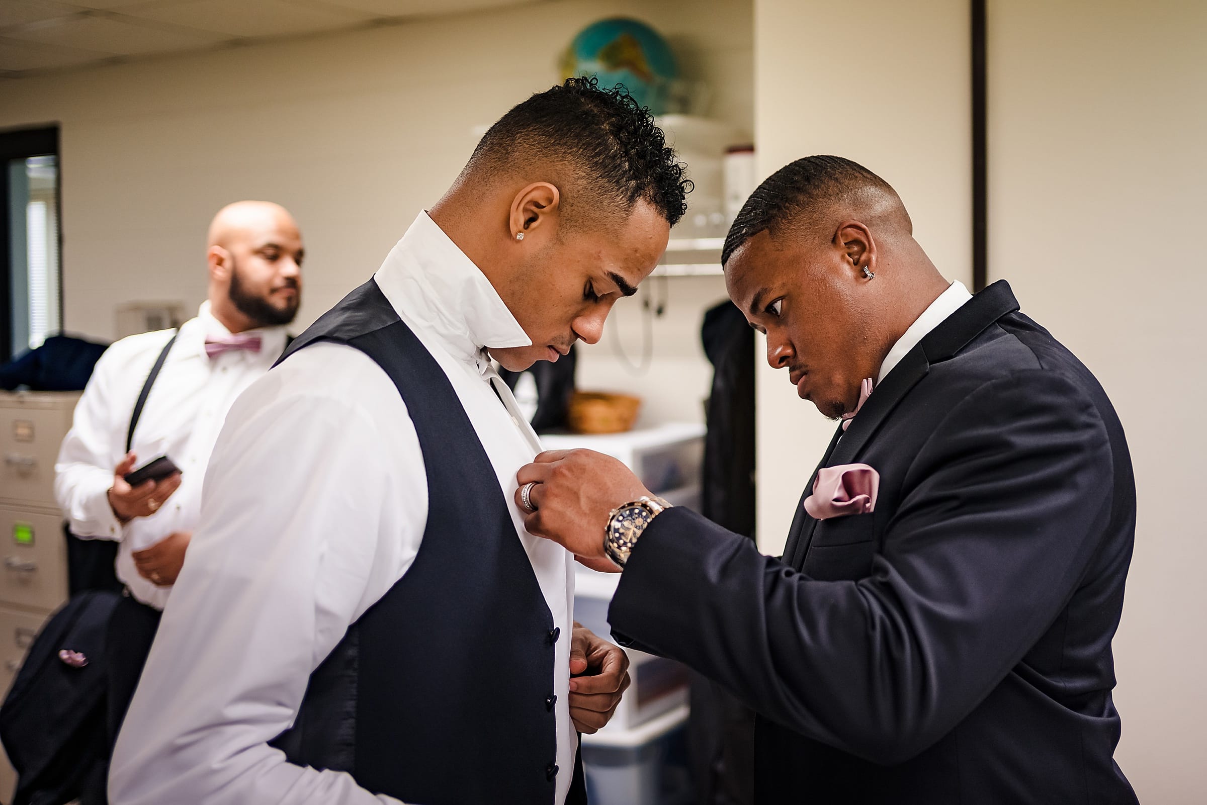 Two young men get dressed for a wedding day