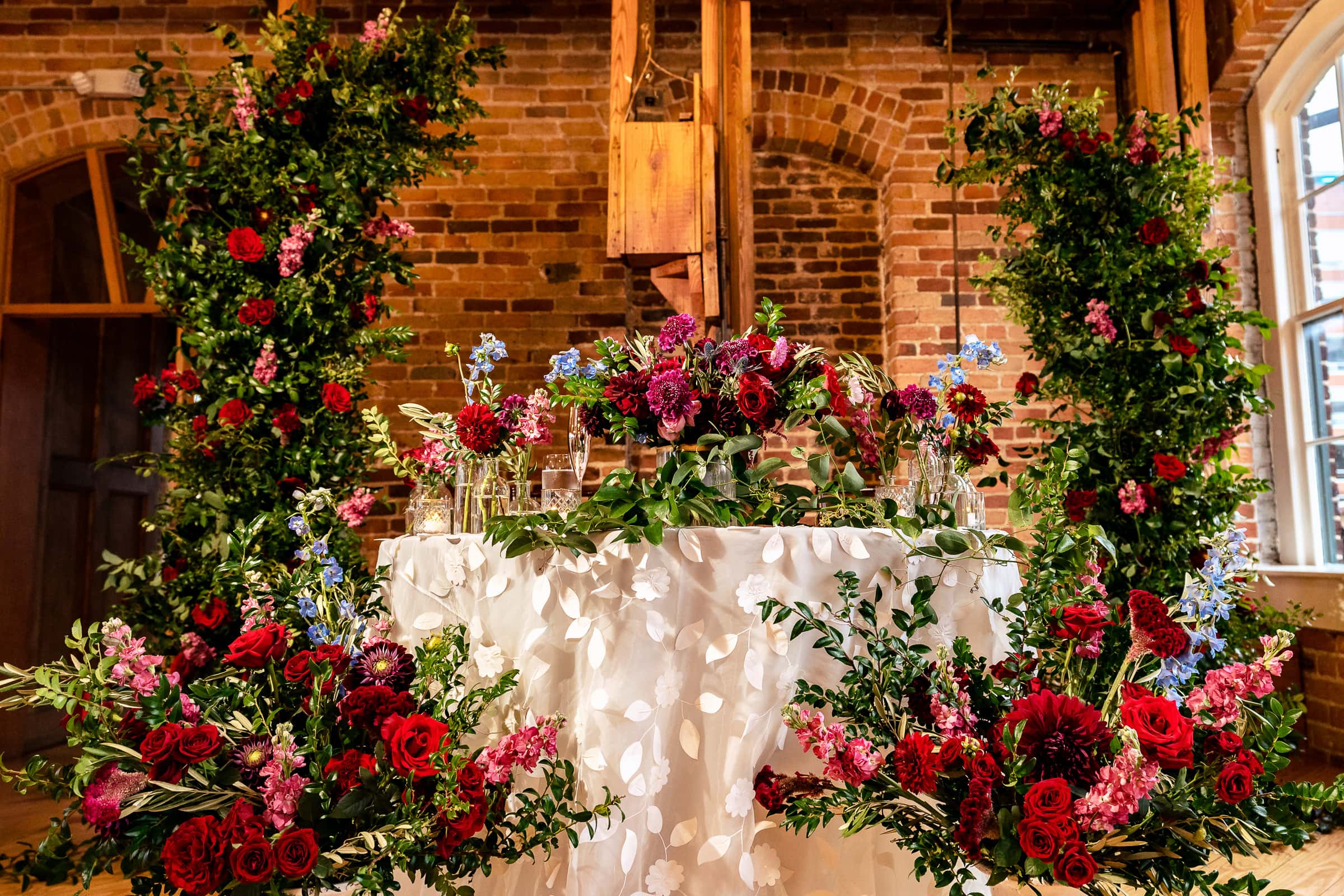 sweetheart table florals and decor by Color Fields Farm at Melrose Knitting Mill | photos by Kivus & Camera