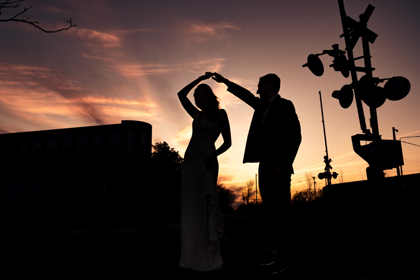 Portrait of a couple in wedding attire outside The Cotton Room wedding venue in Durham, North Carolina | photo by Kivus & Camera