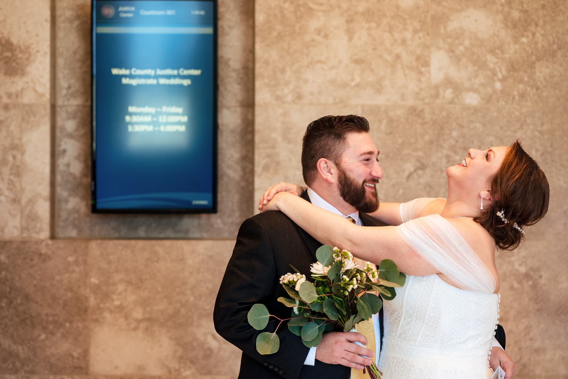 couple embraces at their courthouse wedding in Raleigh, NC | photo by Kivus & Camera