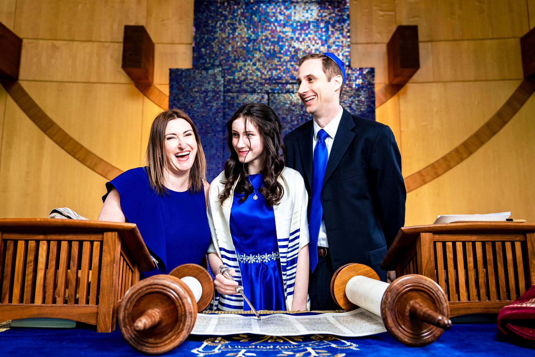 bat mitzvah girl smiles and laughs with her parents at Judea Reform Congregation in Durham, NC