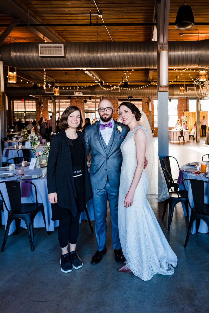 Emily from Emily Katherine Events poses with one of her couples at The Rickhouse. Emily Katherine Events is one of the best NC Wedding Planners. | photo by Kivus & Camera