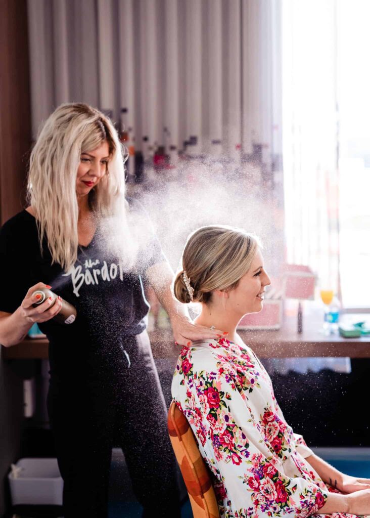 Britnye from The Bardot uses hairspray to finish off a bride's updo | photo by Kivus & Camera