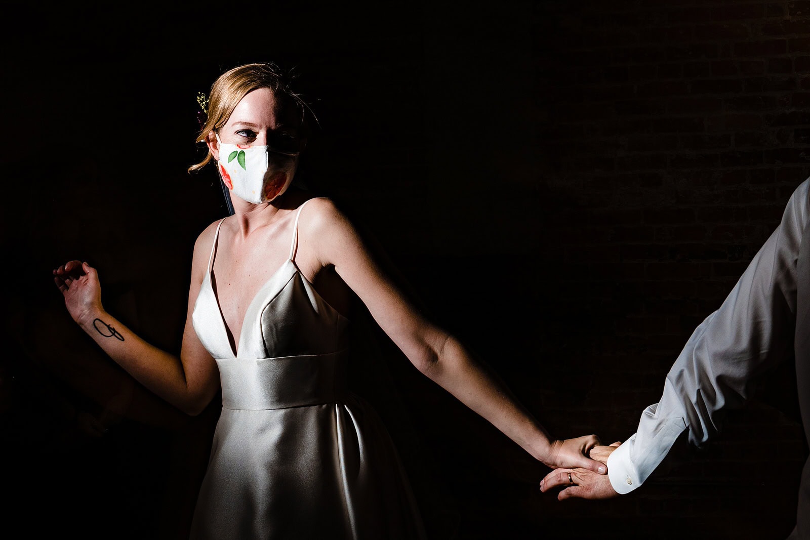 Bride dances in a custom mask on her wedding day