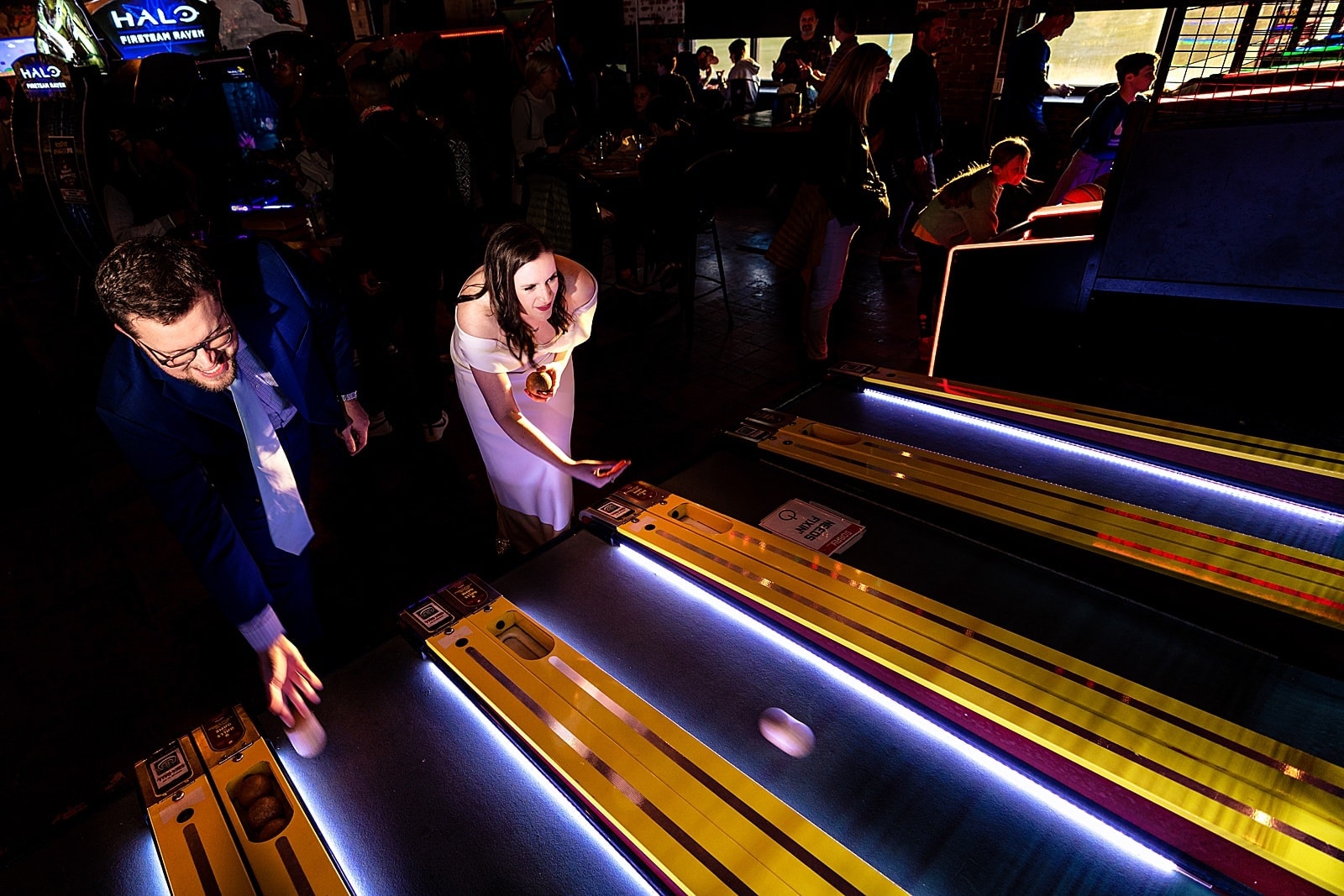 Bride and groom playing arcade games at a Boxcar Bar + Arcade wedding by Durham wedding photographers Kivus & Camera