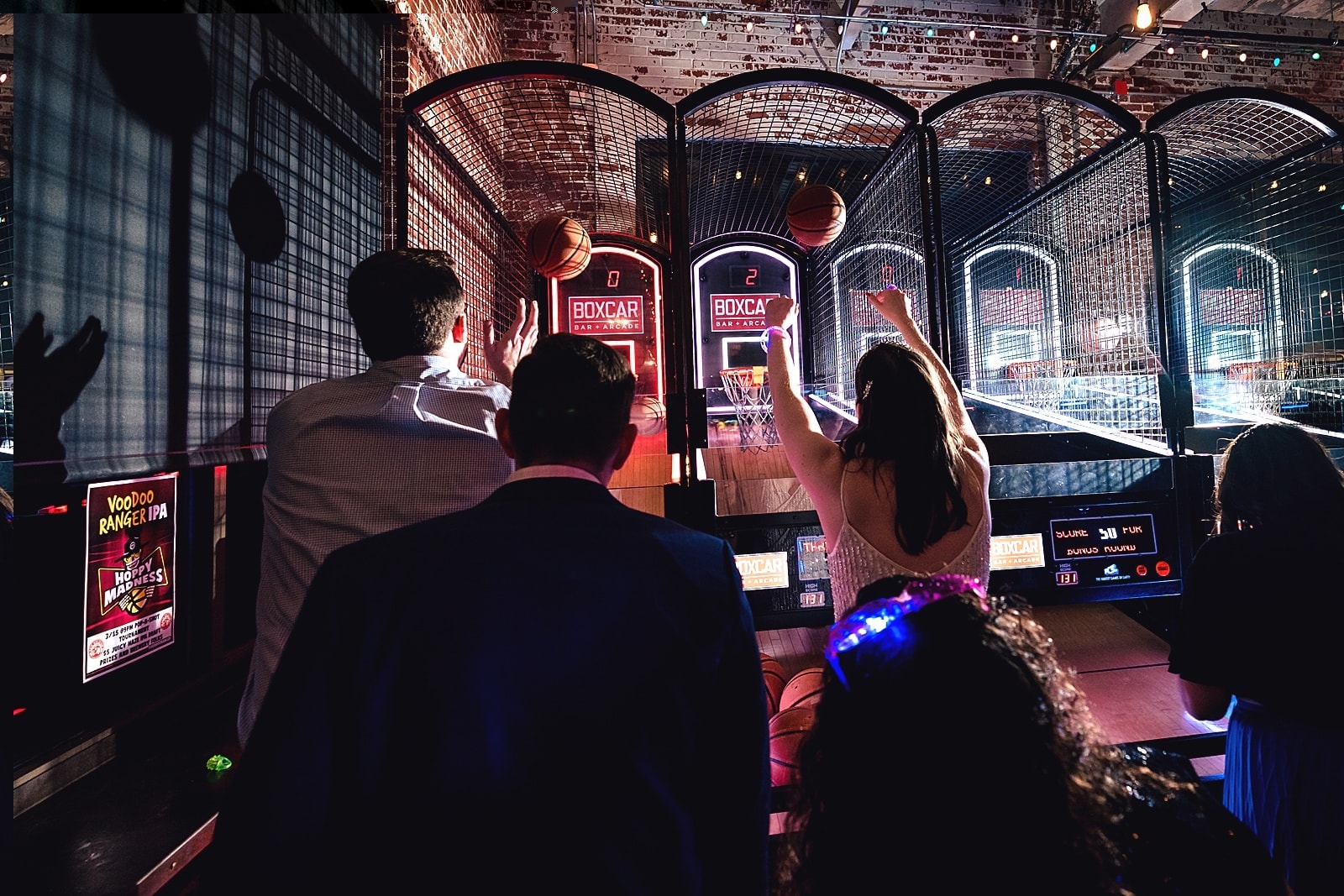 Bride and groom playing arcade games at a Boxcar Bar + Arcade wedding by Durham wedding photographers Kivus & Camera
