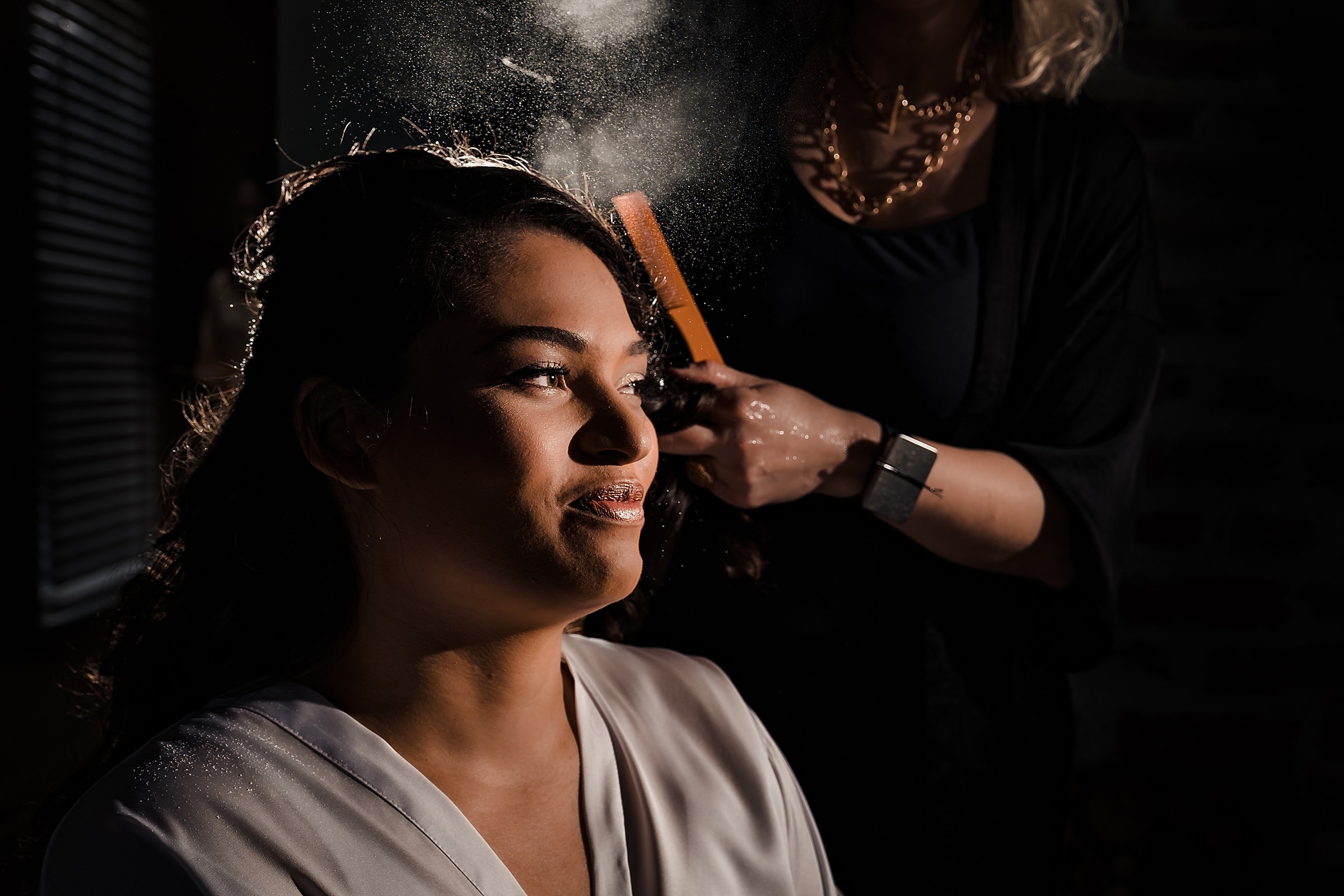 Only photographers who understand lighting can get you this epic hairspray shot while you're getting ready at your wedding