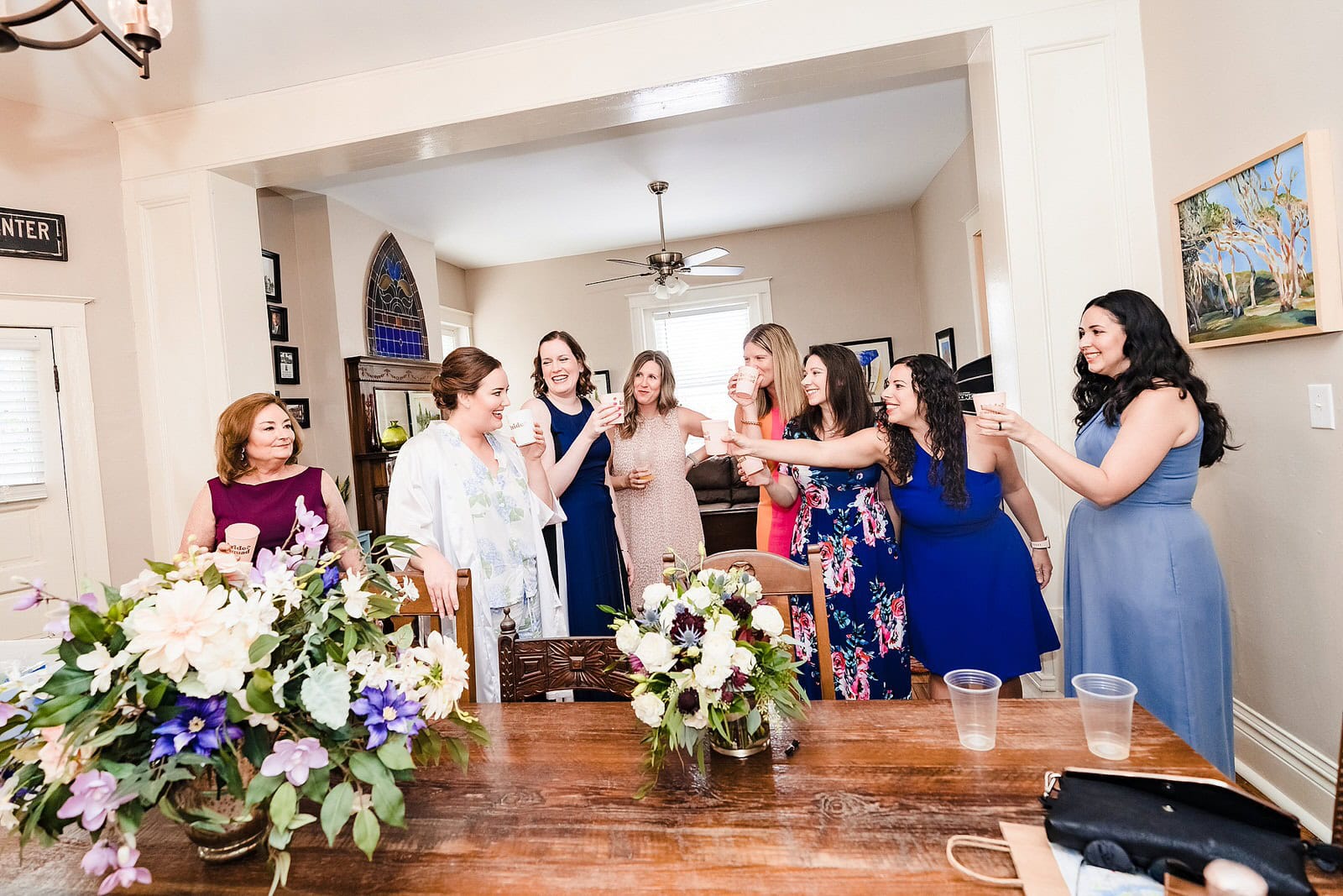 Bride and friends toast before the bride puts on her wedding dress