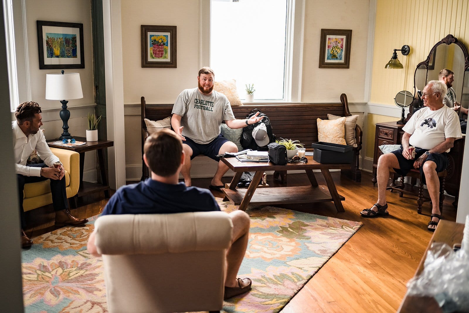 Groom in a Charlotte Football tshirt laughs and talks with his friends and family before his wedding