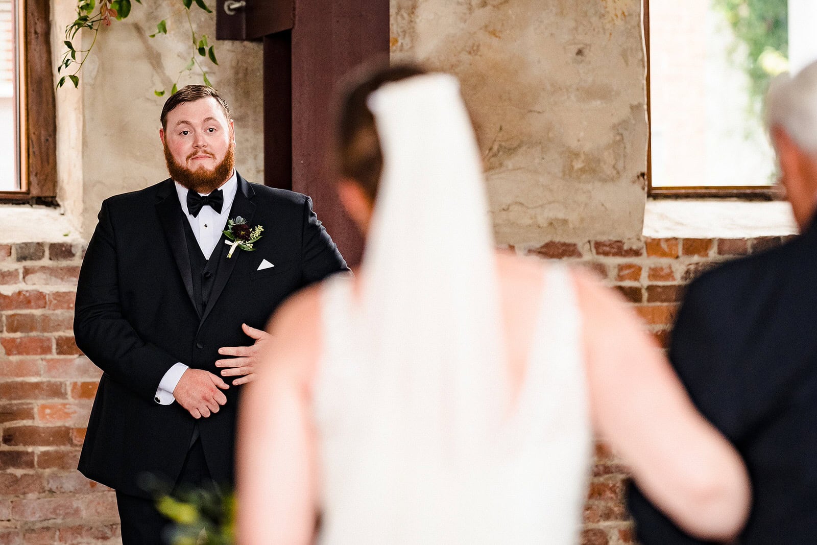 Groom holds back tears as he sees the bride walk down the aisle for the first time