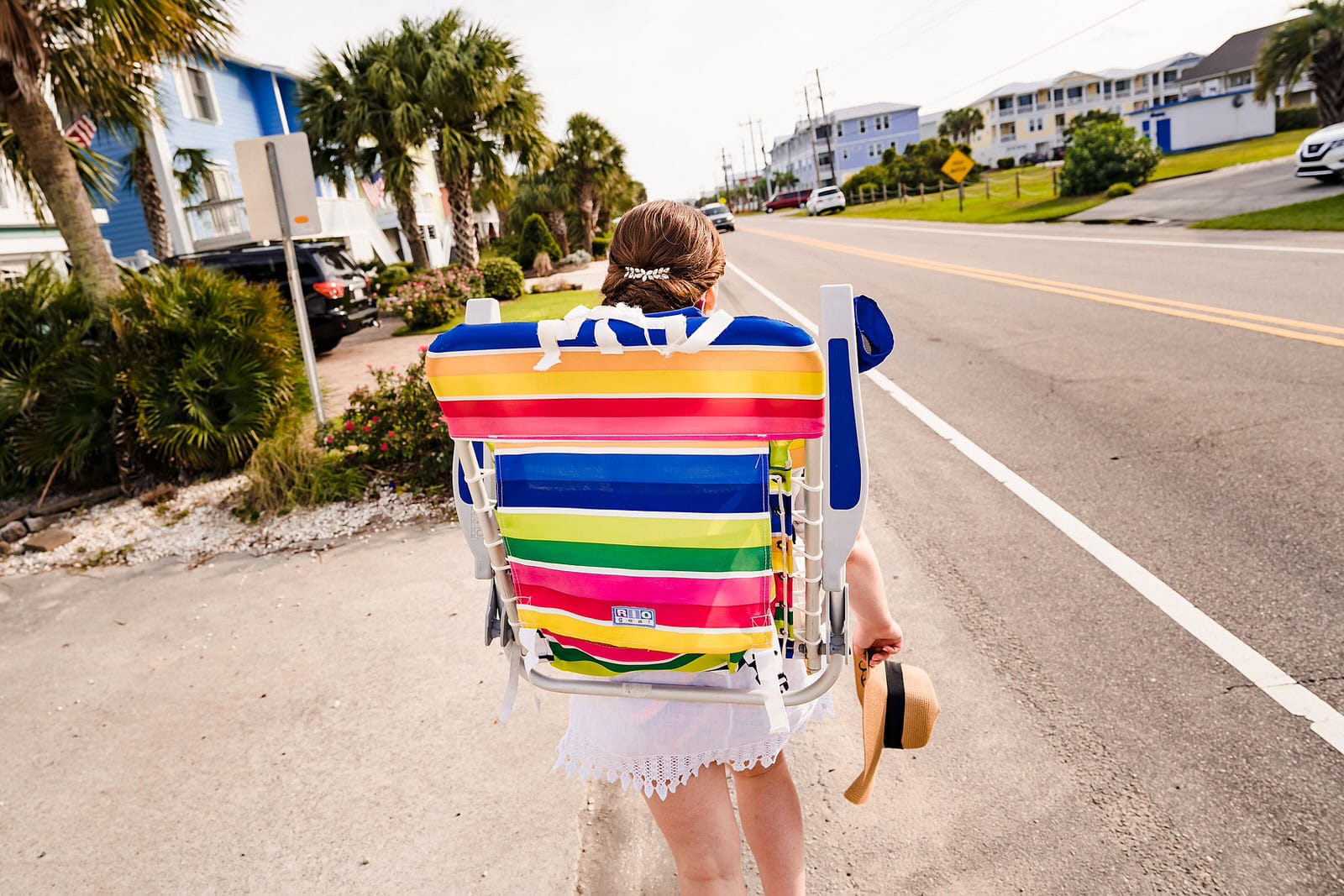 bride walks to the beach after her wedding