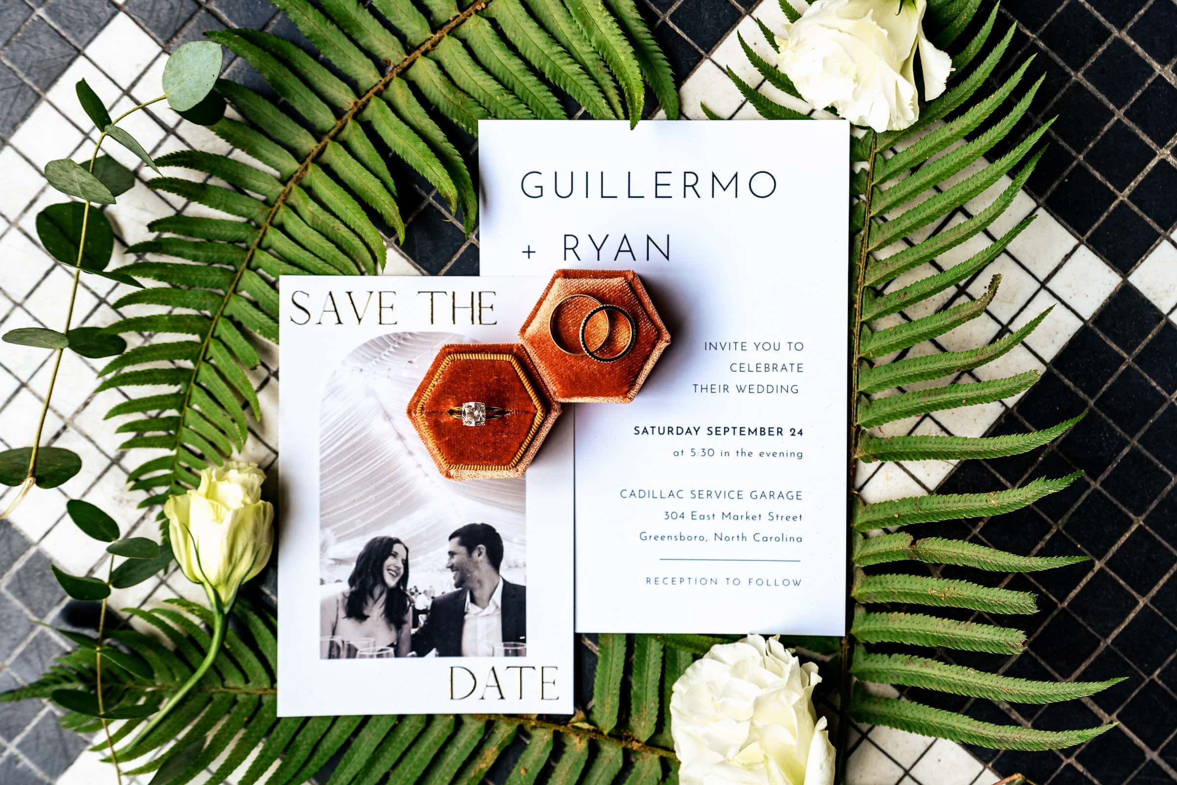 detail photo of rings & invitations at a Cadillac Service Garage wedding | photos by Kivus & Camera