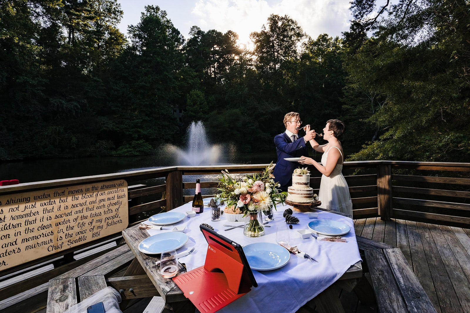 couple feeds one another cake at their chapel hill elopement
