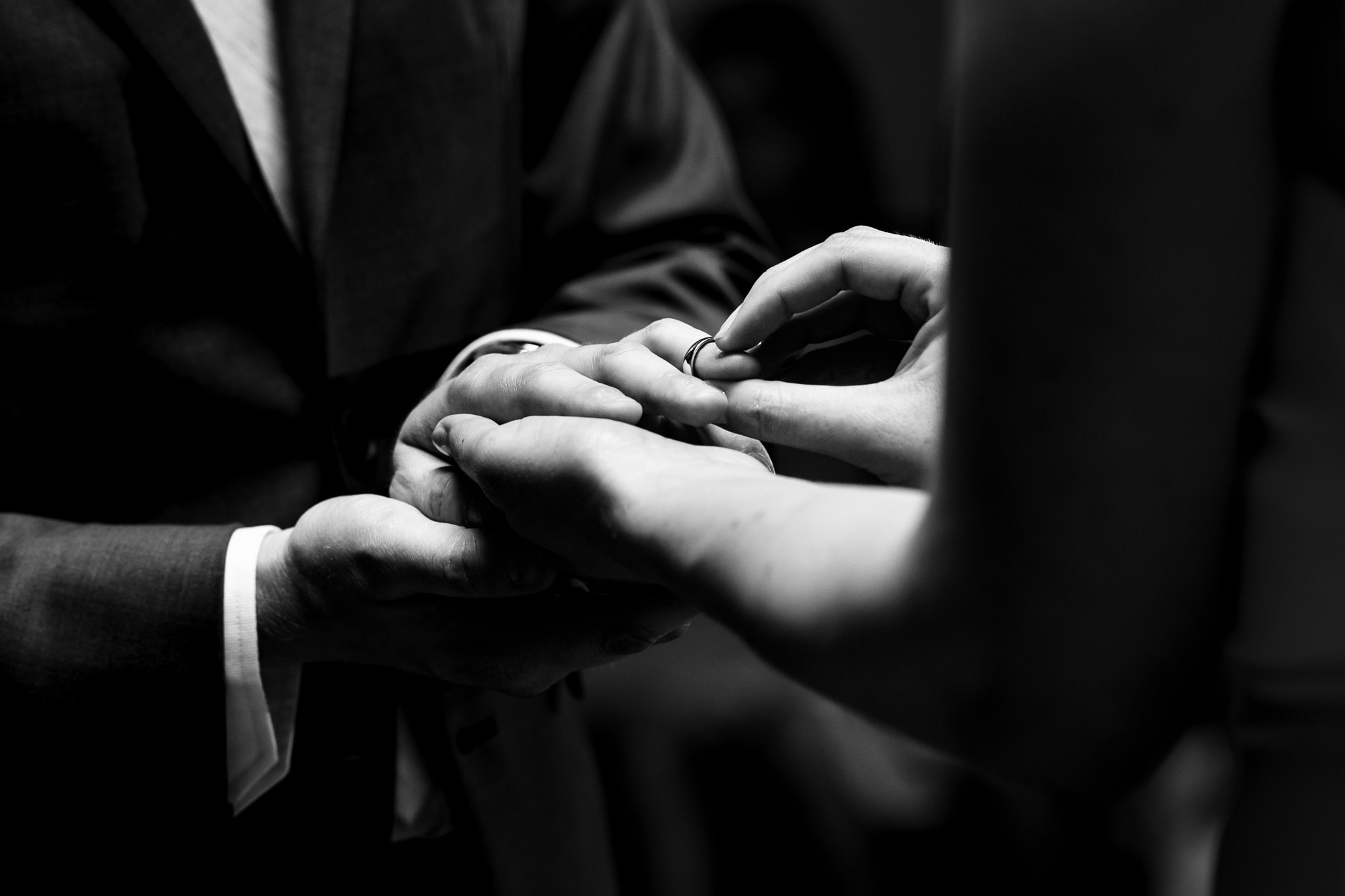 closeup of bride placing wedding ring on groom's finger | photo by Kivus & Camera