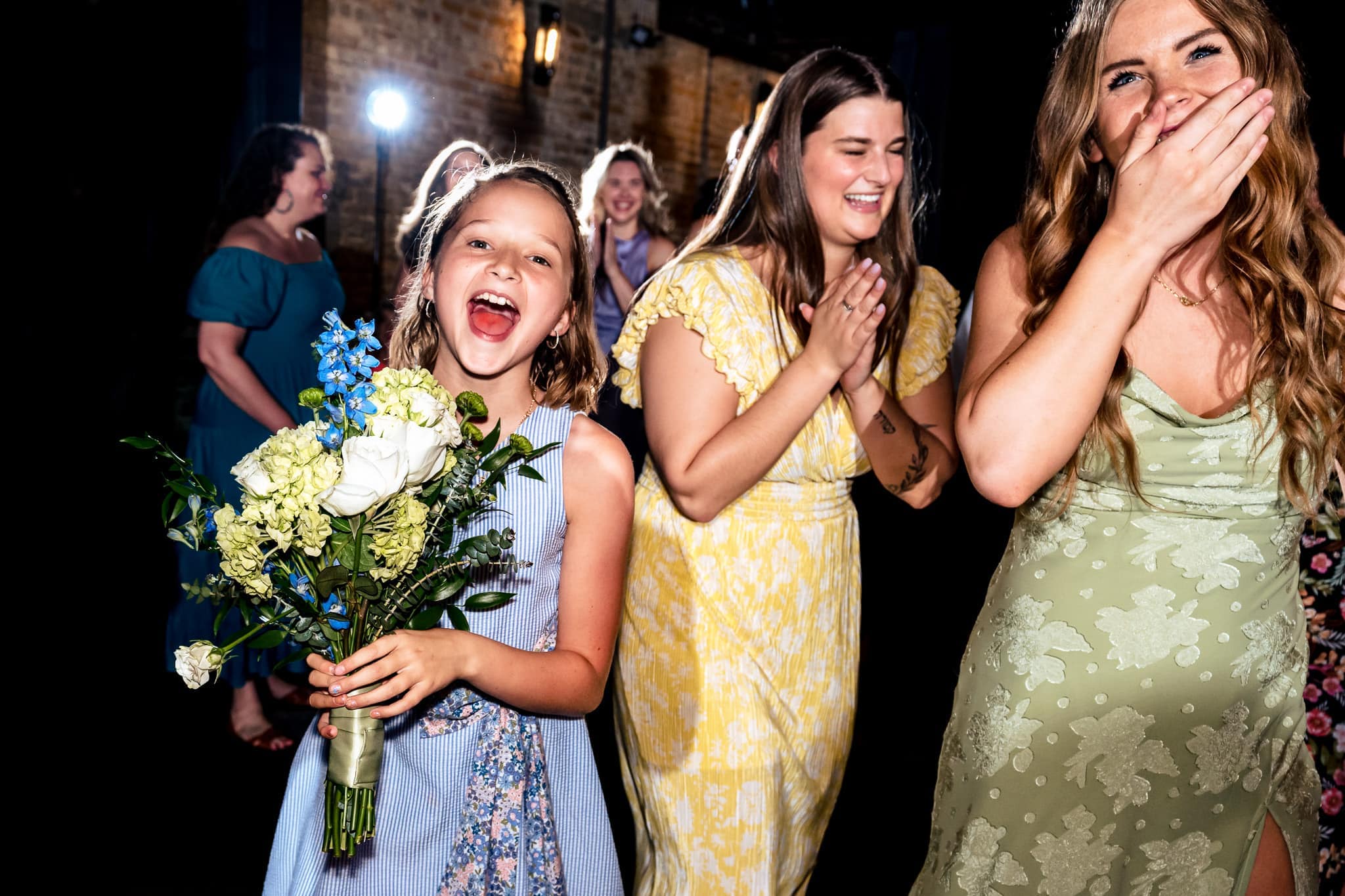 hilarious bouquet toss at The Grove at City Market | photo by Kivus & Camera