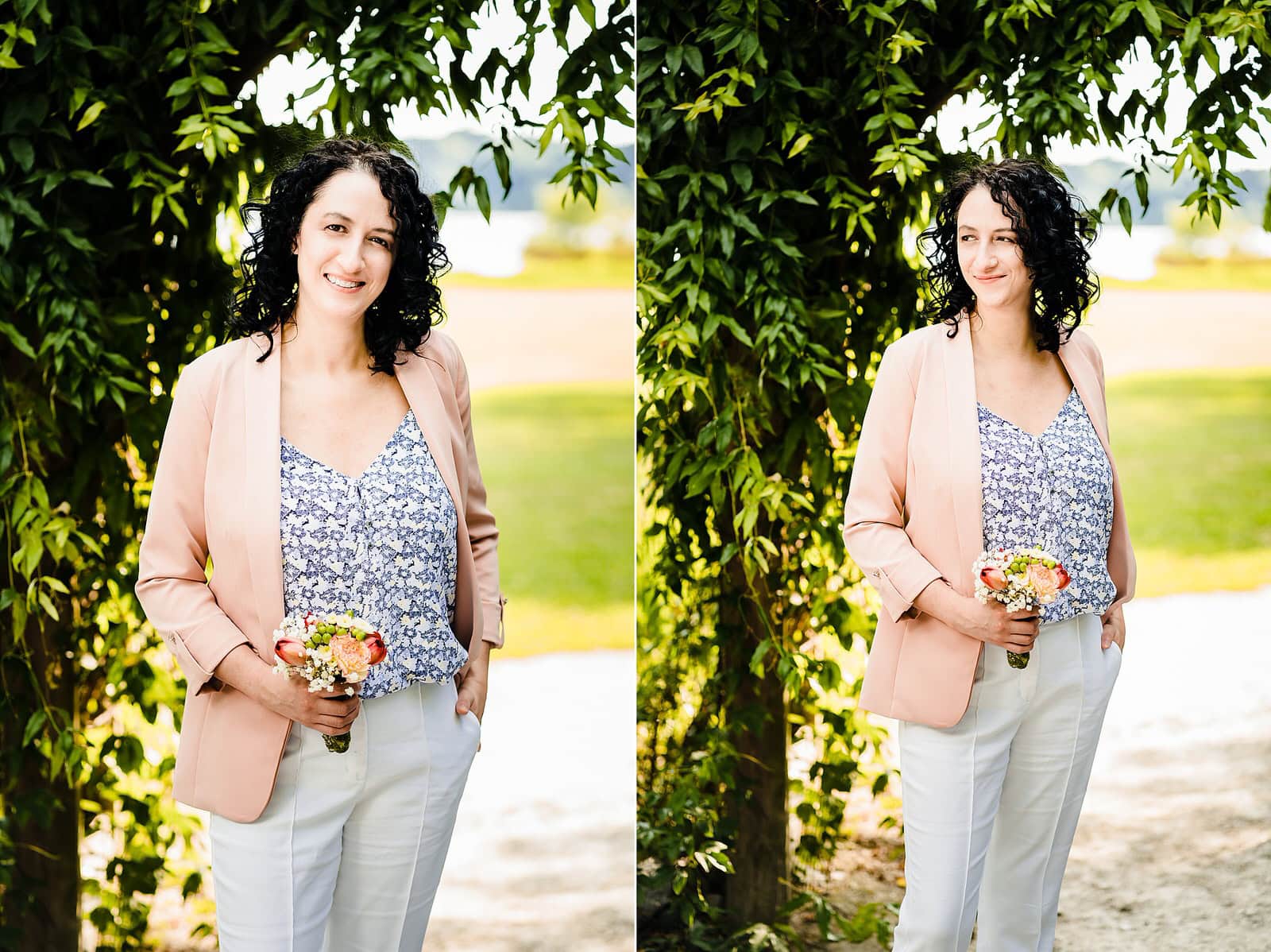 Portrait of the bride on her wedding day. She wears white pants and a pink blazer. 