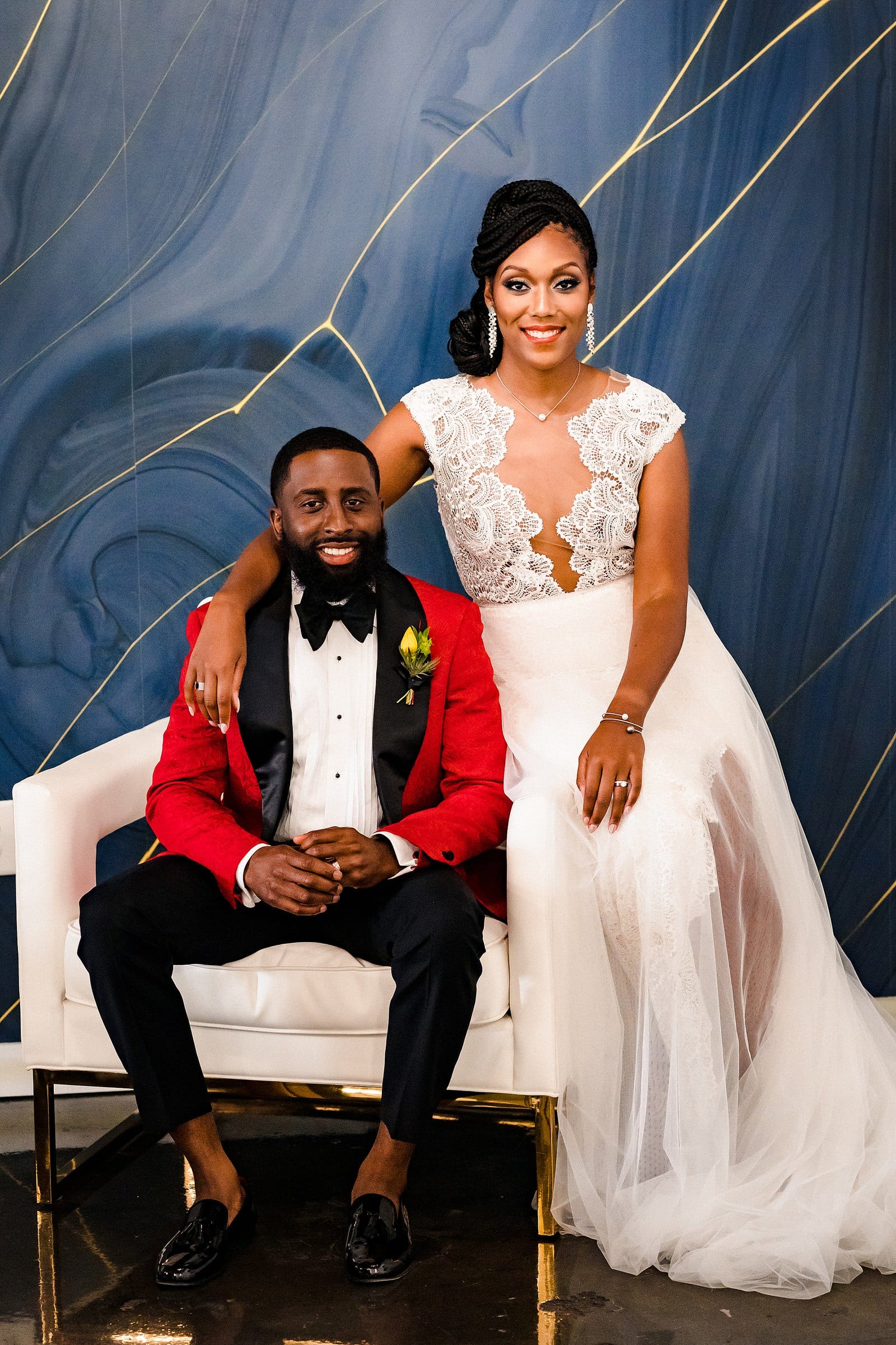 Groom in a Robert Jamison Collection custom suit and bride in a Gavin Christianson Bridal gown pose in the bridal suite at the Cotton Room