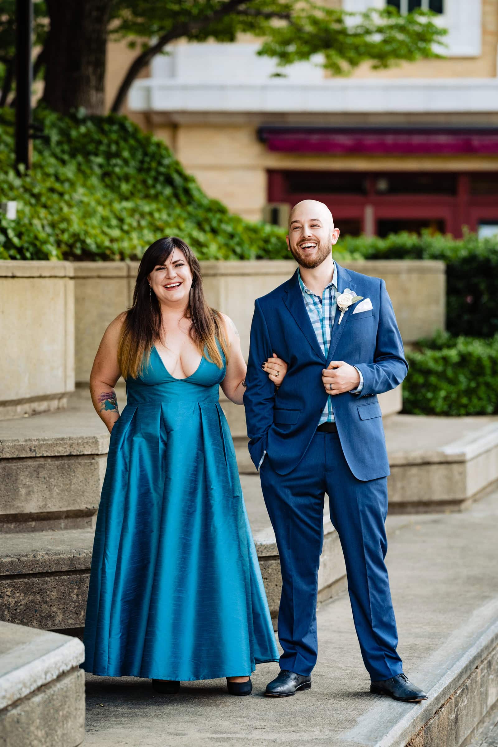 Man and woman laugh at the camera, posing for Durham anniversary portraits