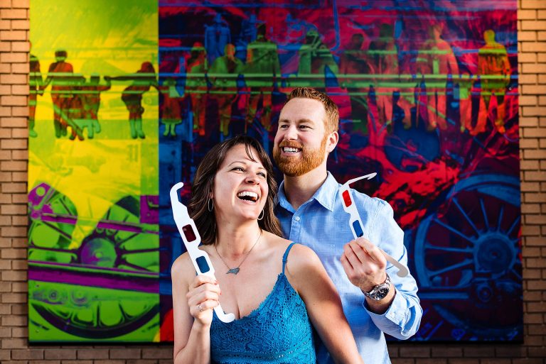 Downtown Durham engagement portrait in front of 3D mural