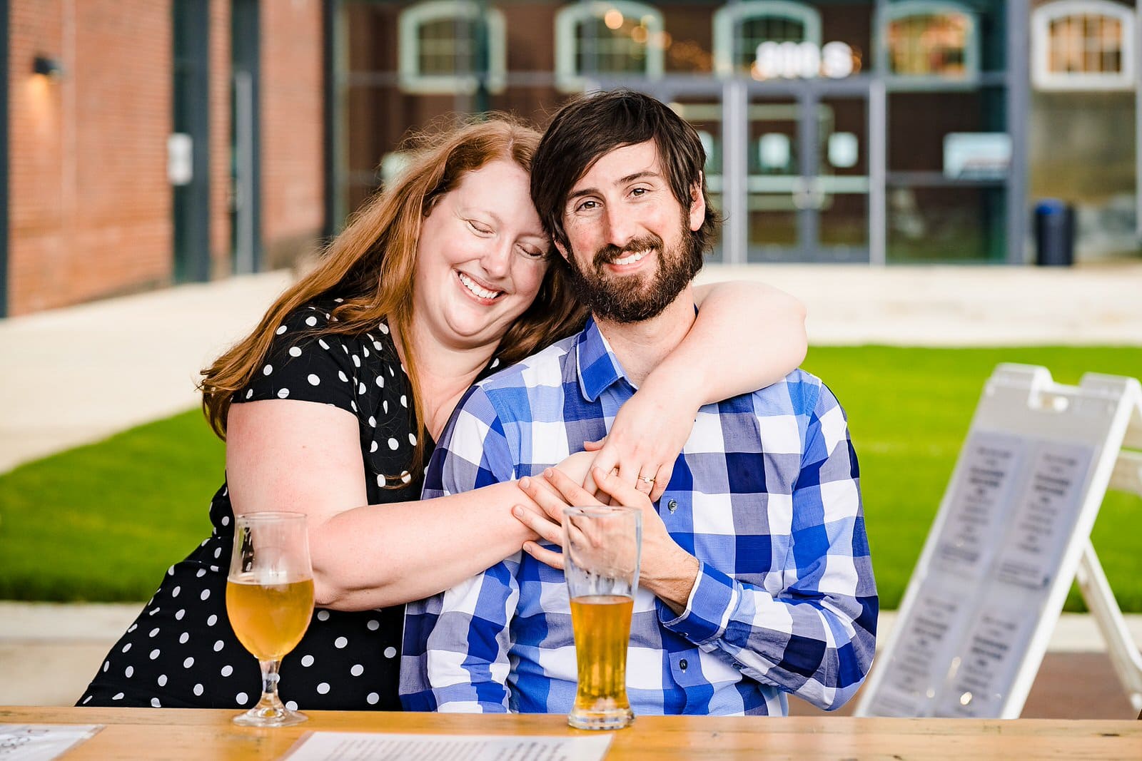 A woman embraces her fiance during their Durham engagement photos