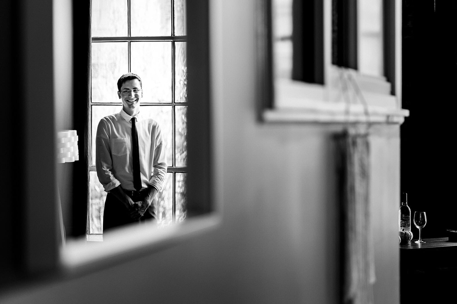 Groom smiles as he sees the bride walk into the wedding ceremony