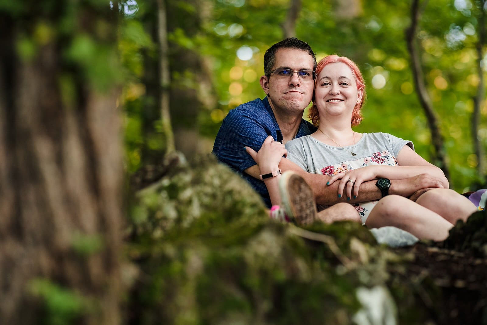 A man and a woman smile for an engagement portrait at West Point on the Eno