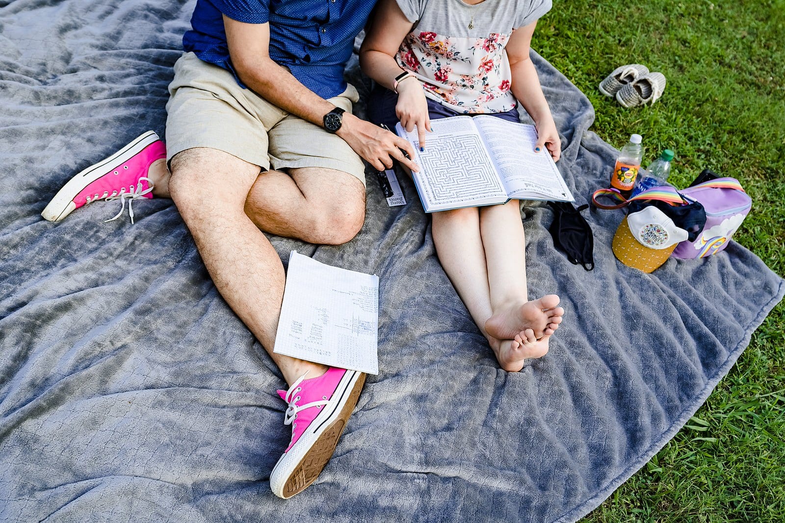 Engaged couple solve a puzzle book during their nerdy engagement photos