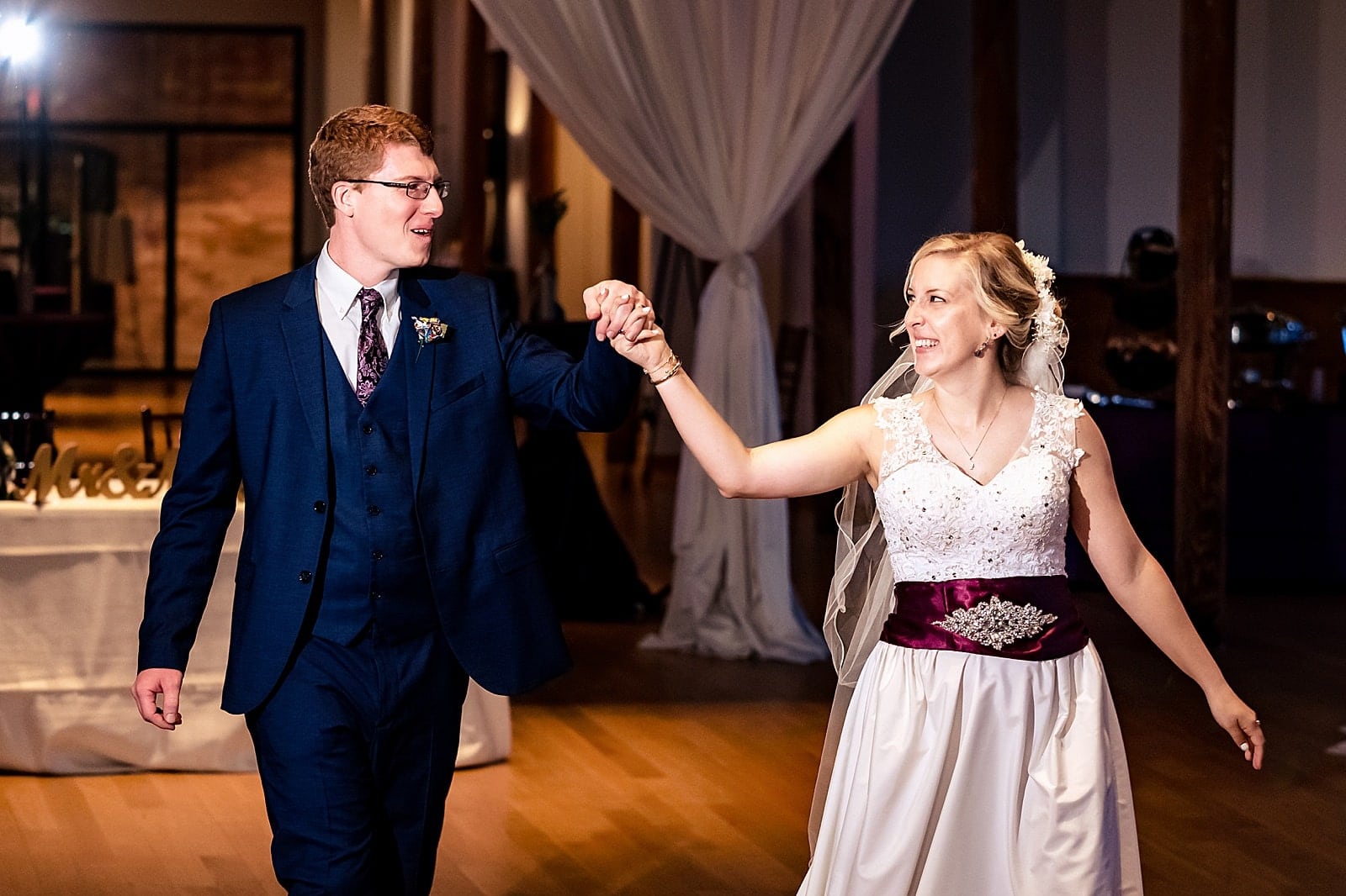 Bride and groom enter their wedding reception at The Cotton Room