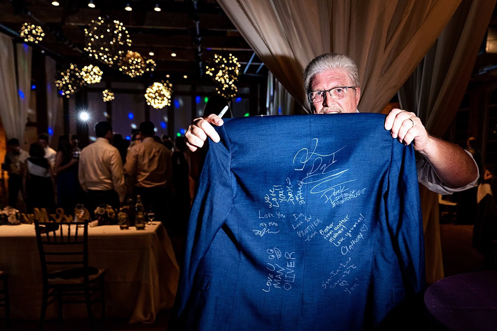 This groom's groomsmen signed his suit jacket as part of a group tradition