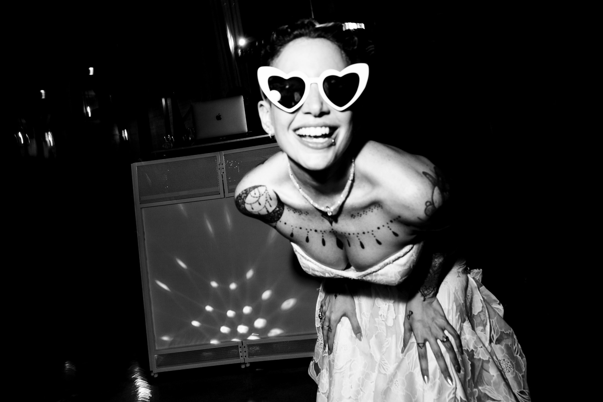 Bride wearing heart shaped white sunglasses at her wedding reception | Kivus & Camera
