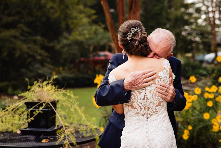 Bride hugs her grandfather before her wedding ceremony