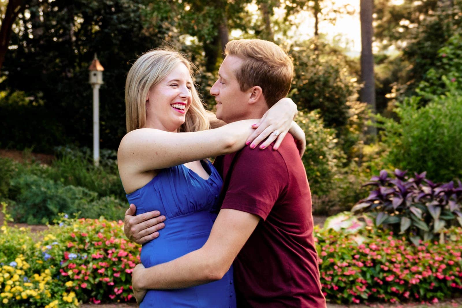 an engaged couple dances in a garden creative engagement photography at Killjoy Cocktail bar in Raleigh, NC | photos by Kivus & Camera