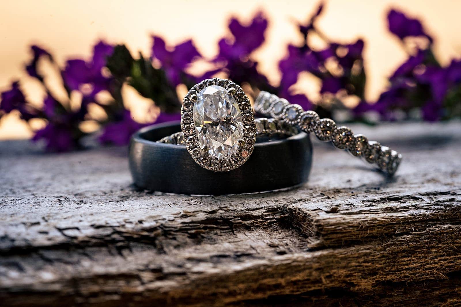 wedding rings in front of lavender