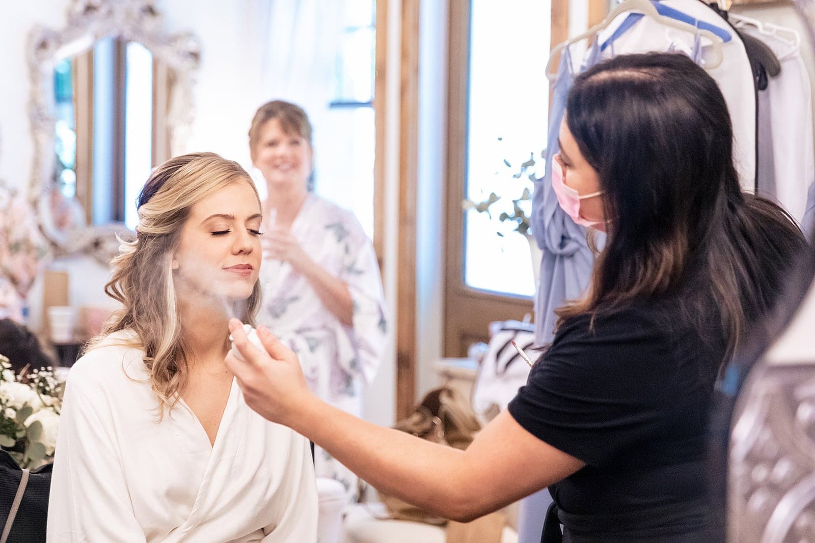 a mom's happy smile as her daughter gets ready on the wedding day