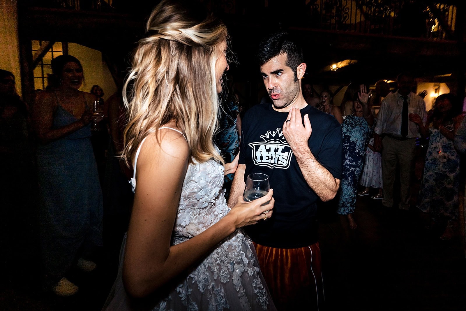 this groom changed into an orange velour jumpsuit for his reception