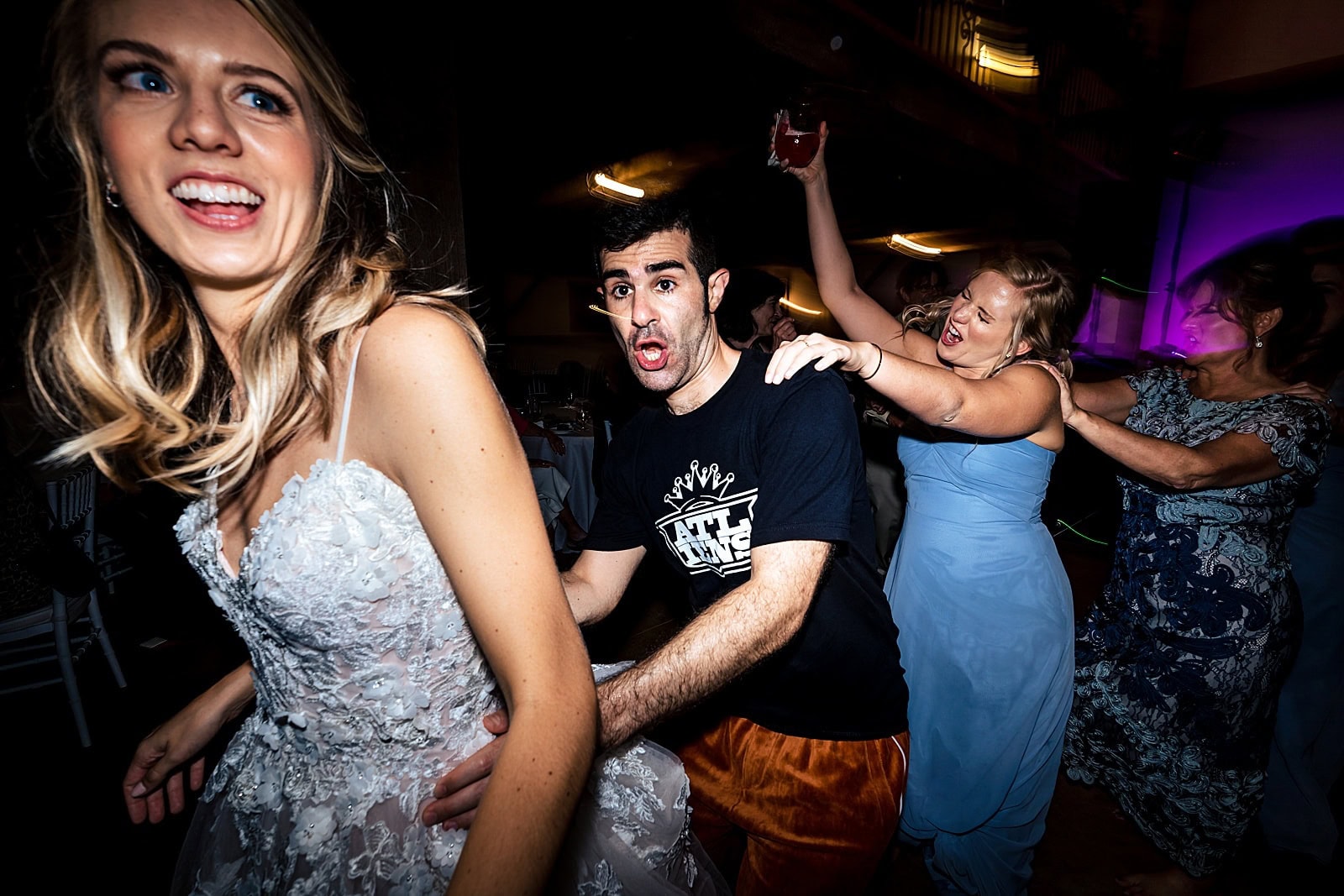 this groom changed into an orange velour jumpsuit for his reception