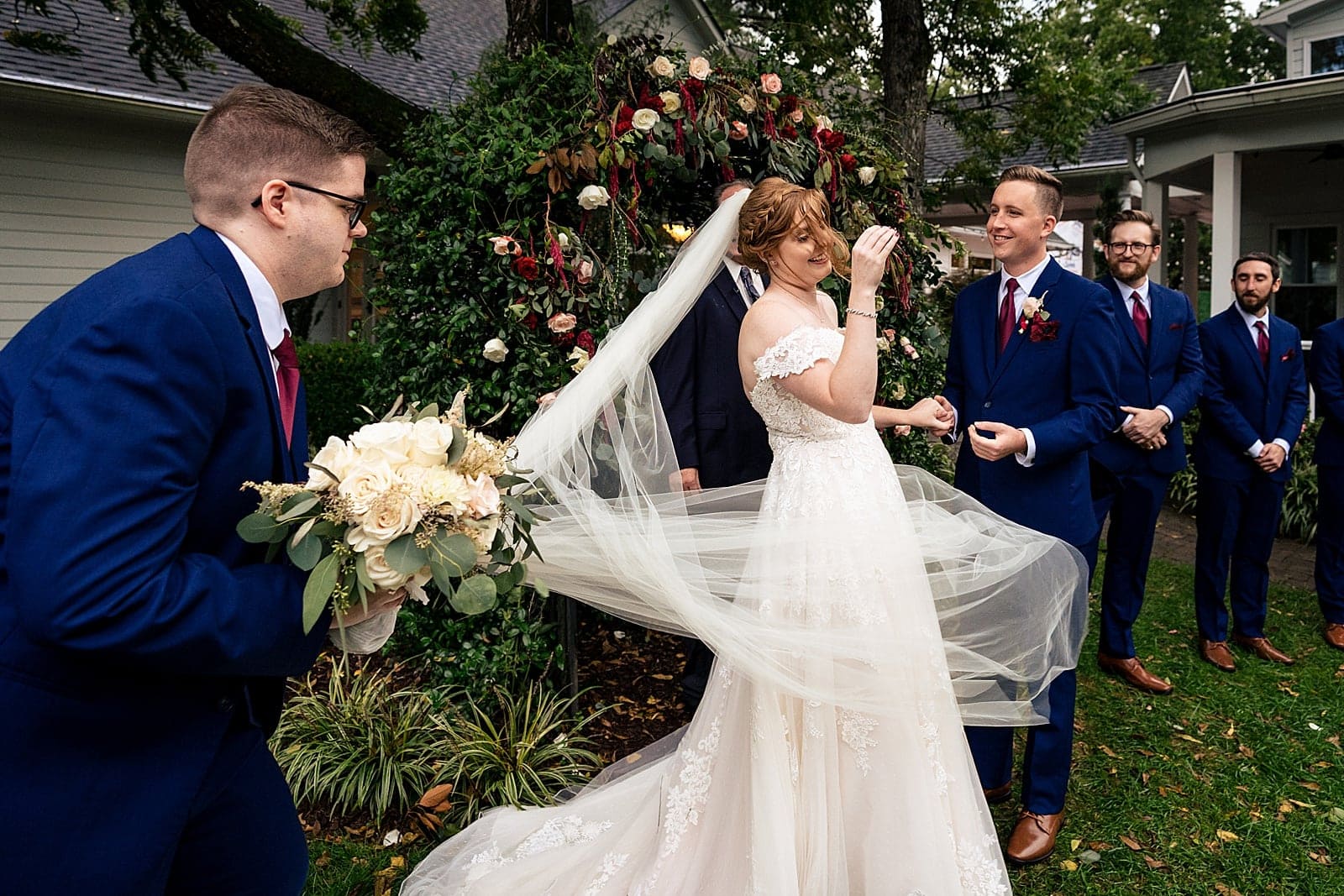 wind tries to take control of bride's veil at this wedding ceremony