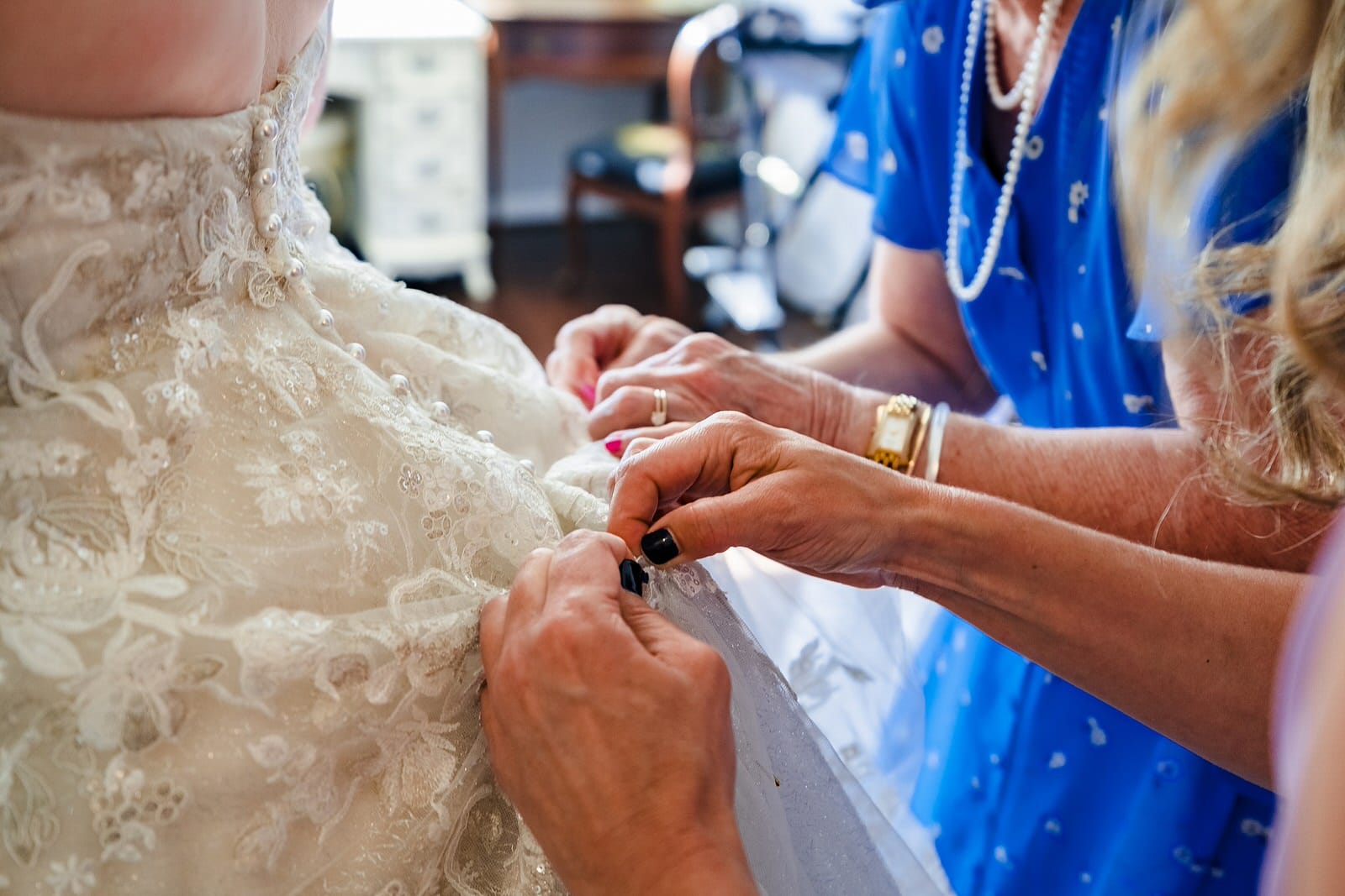 The bride's mother and sister bustle her dress - factor in time for this, especially if you have a complicated bustle