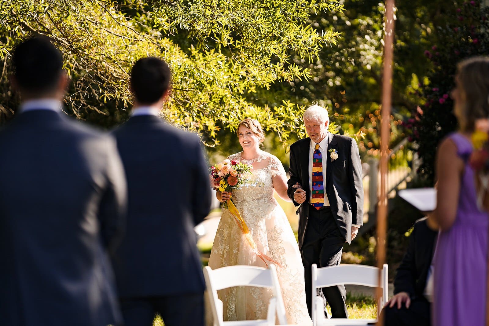 Bride and her father walk down the aisle at the Meadows Raleigh
