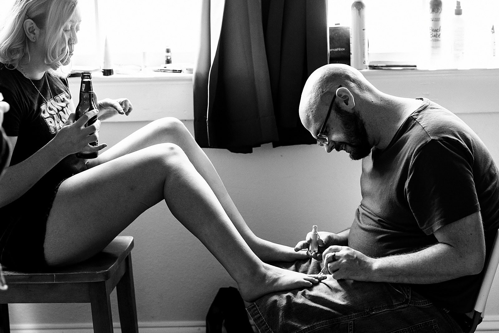brides gets her fingernails and toenails painted on her wedding day