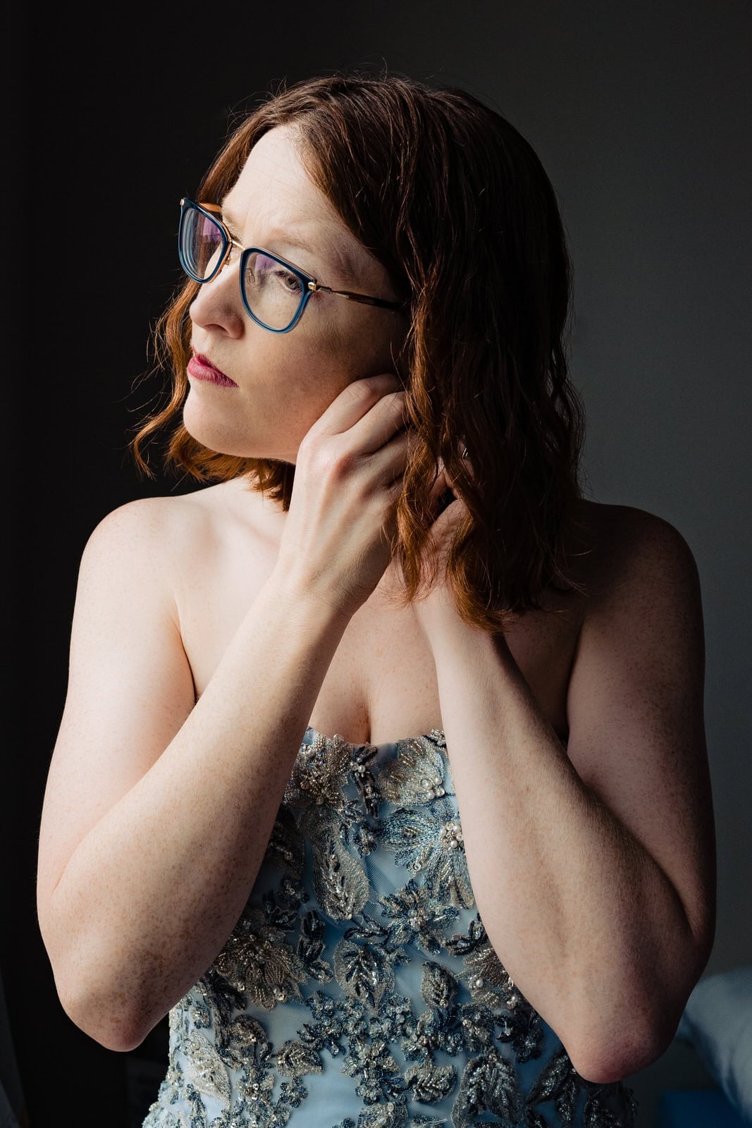 bride puts her earrings in before big fake quarantine wedding