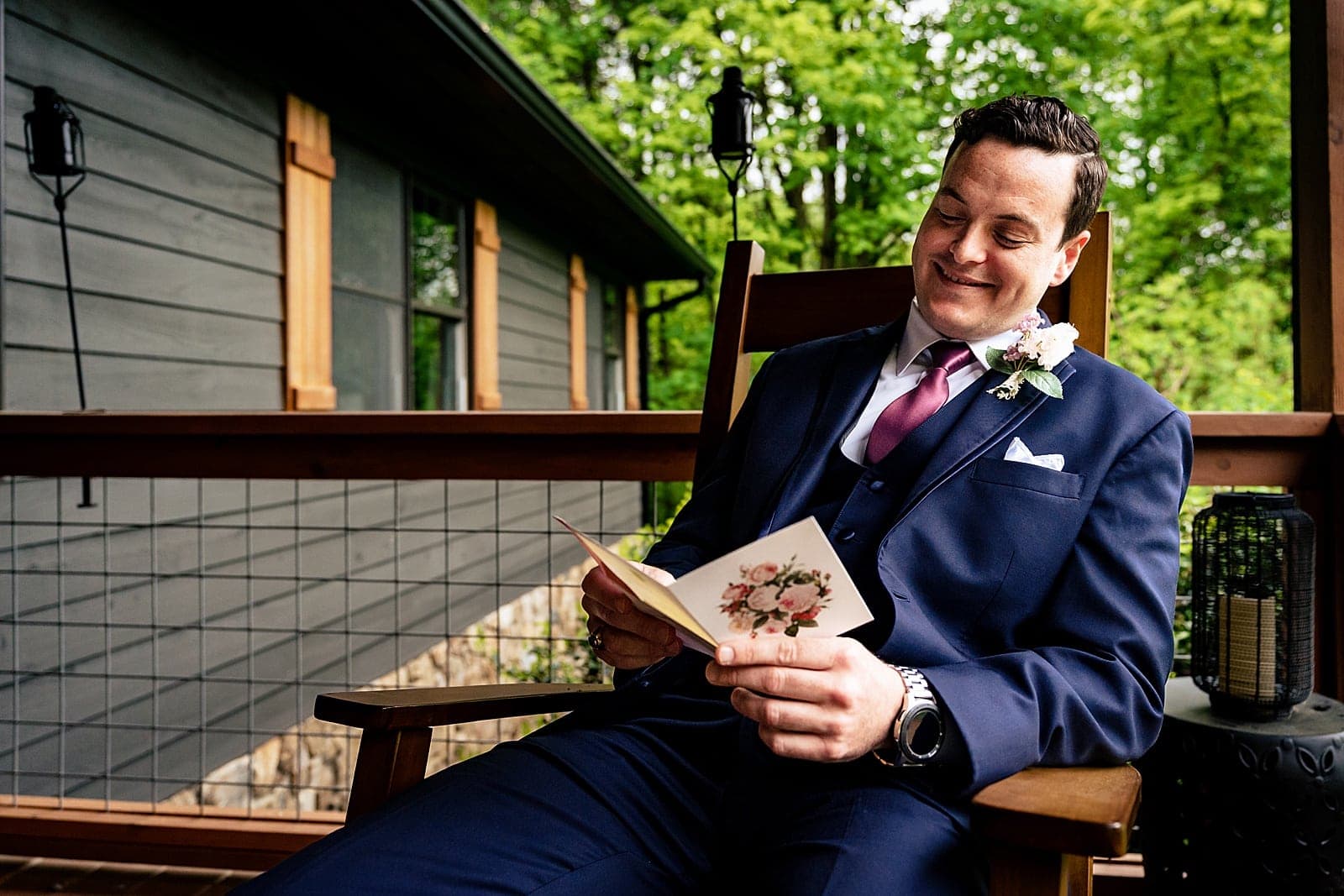 Groom reads a letter from the bride on the morning of their mountain cabin wedding | photos by Kivus & Camera