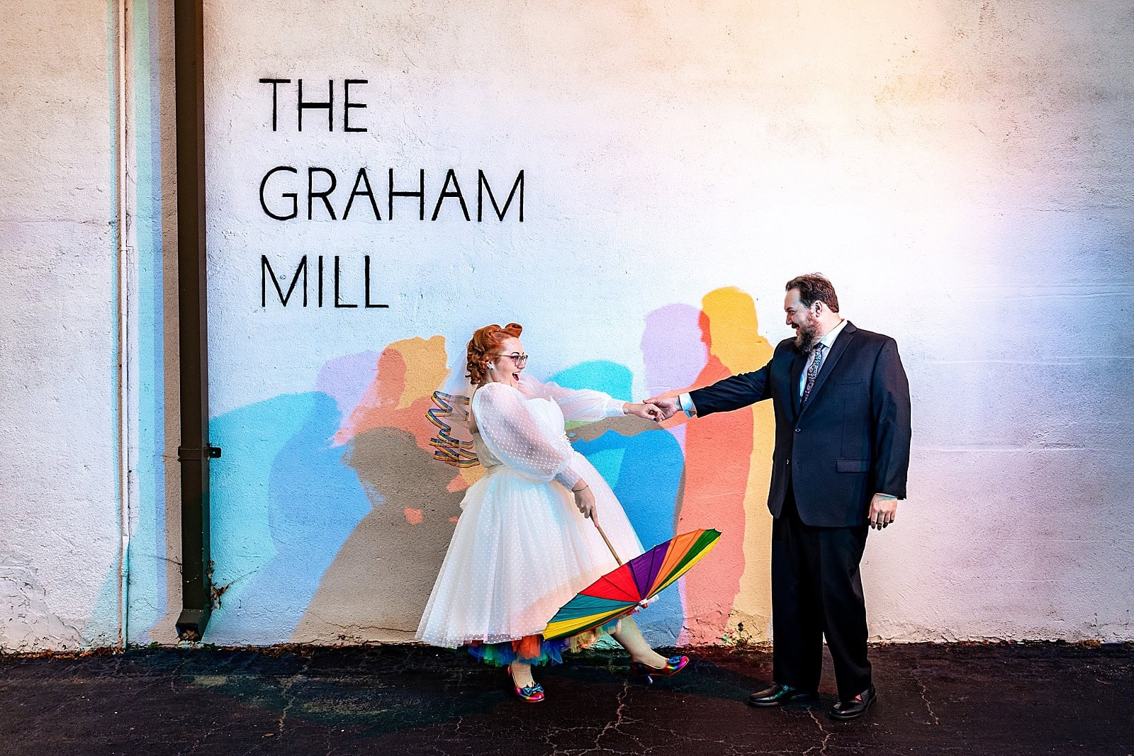 This bride had a rainbow petticoat and a rainbow parasol and a rainbow veil and she's just the best - awesome nerdy Graham Mill wedding