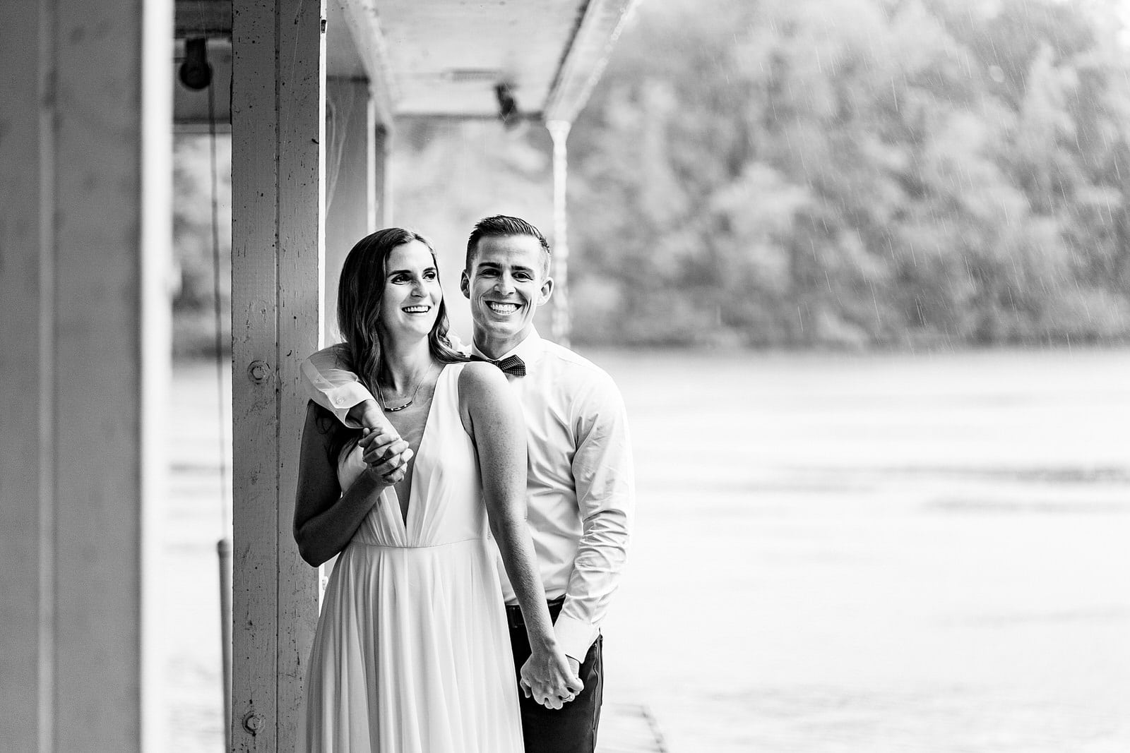 groom embraces bride as they both laugh and smile at their micro-wedding