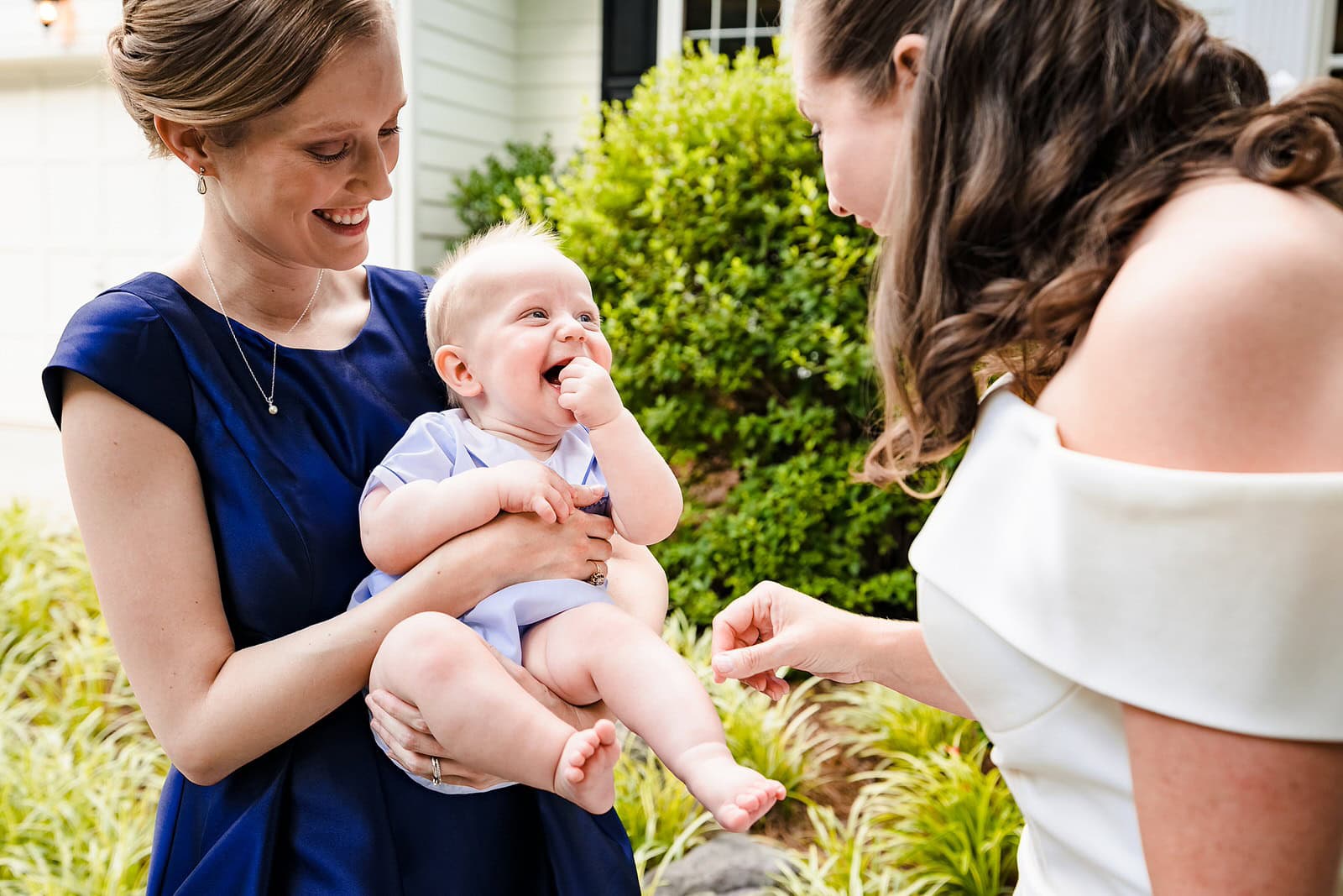 bride interacts with her baby nephew on her wedding day at a micro-wedding